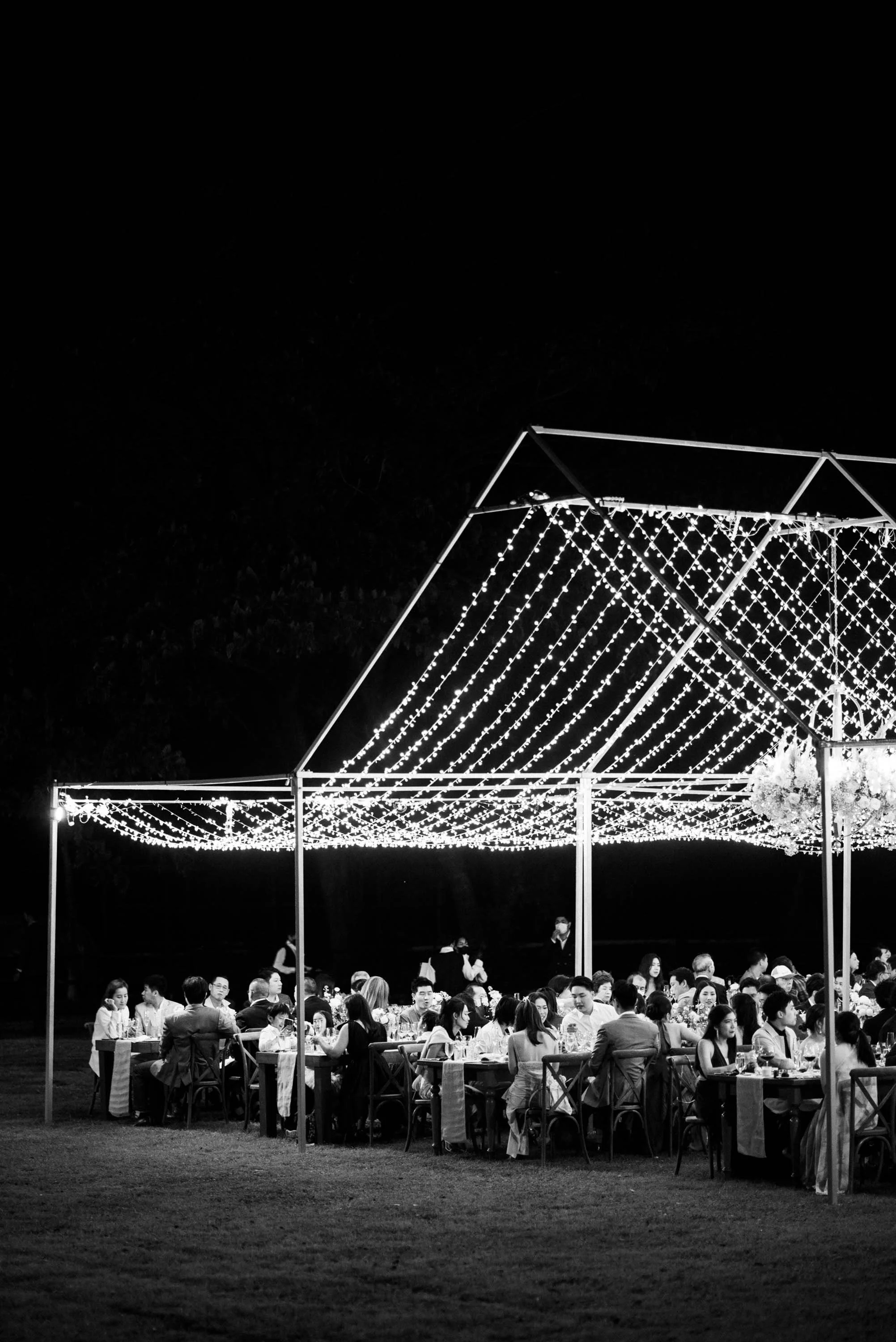 Wedding guests sitting together, eating and talking during dinner.