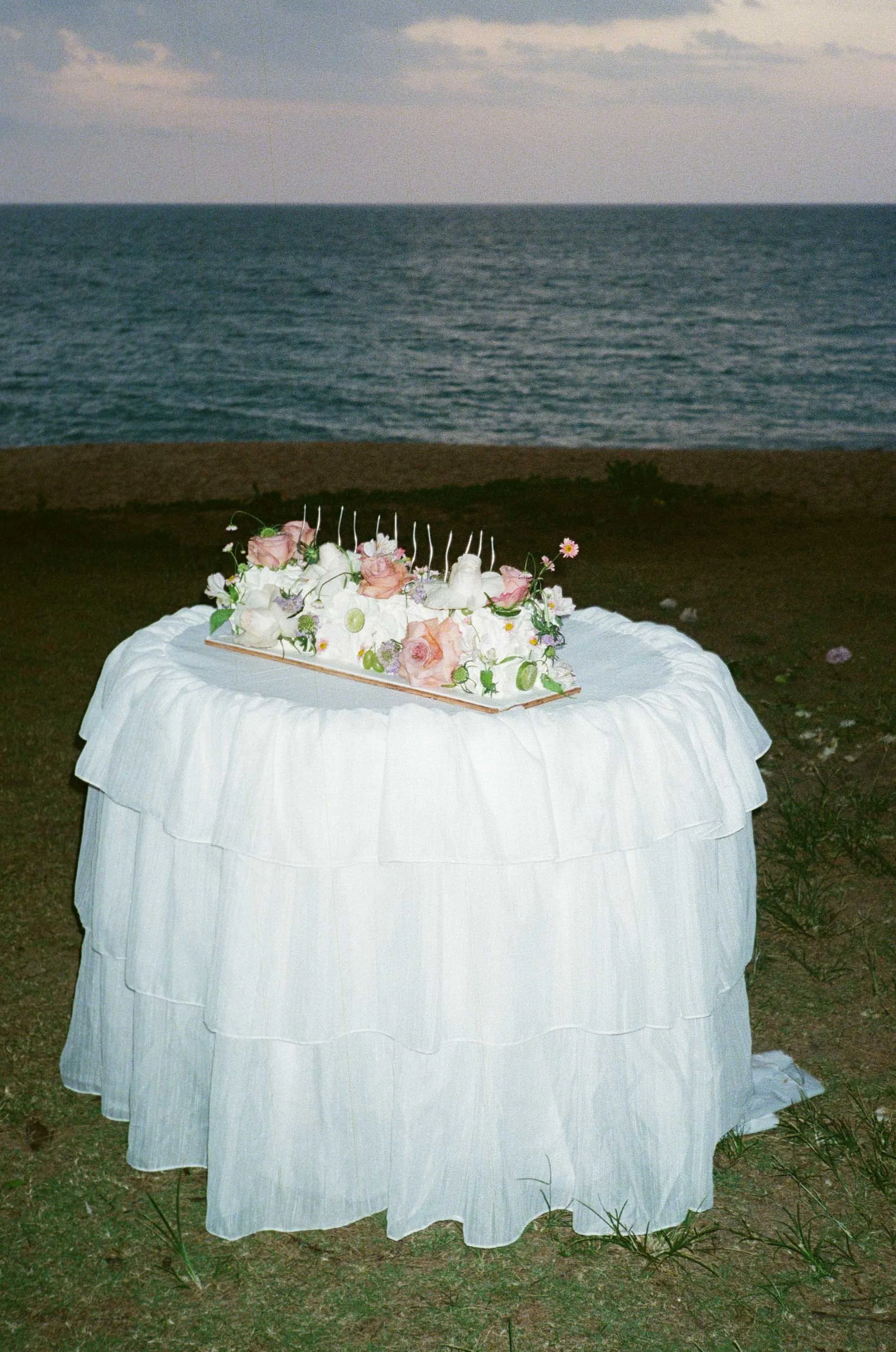 Wedding cake table prepared beside the beach.