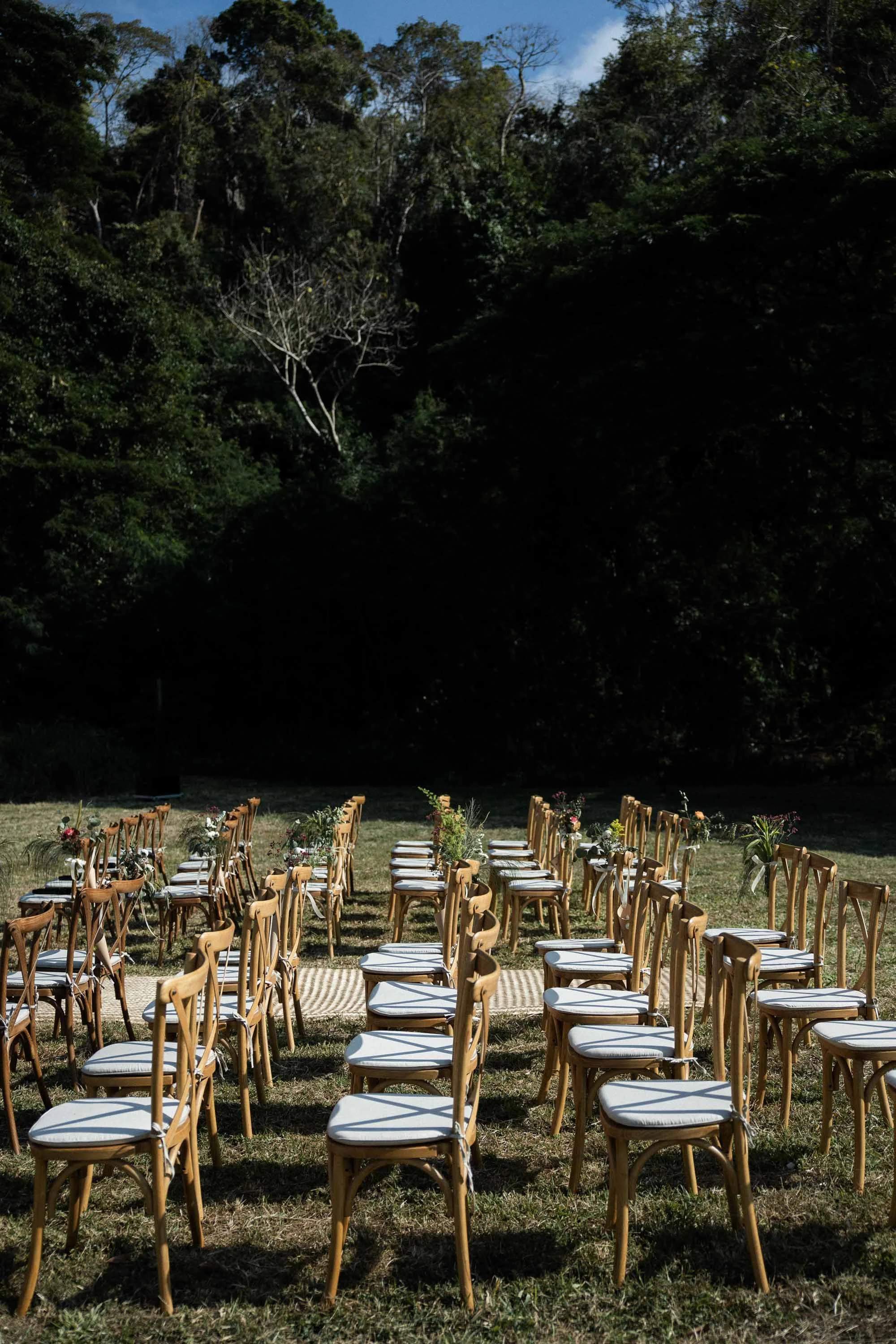 Ceremony chairs arranged beneath the trees at Issara Estates Winery, Khao Yai.