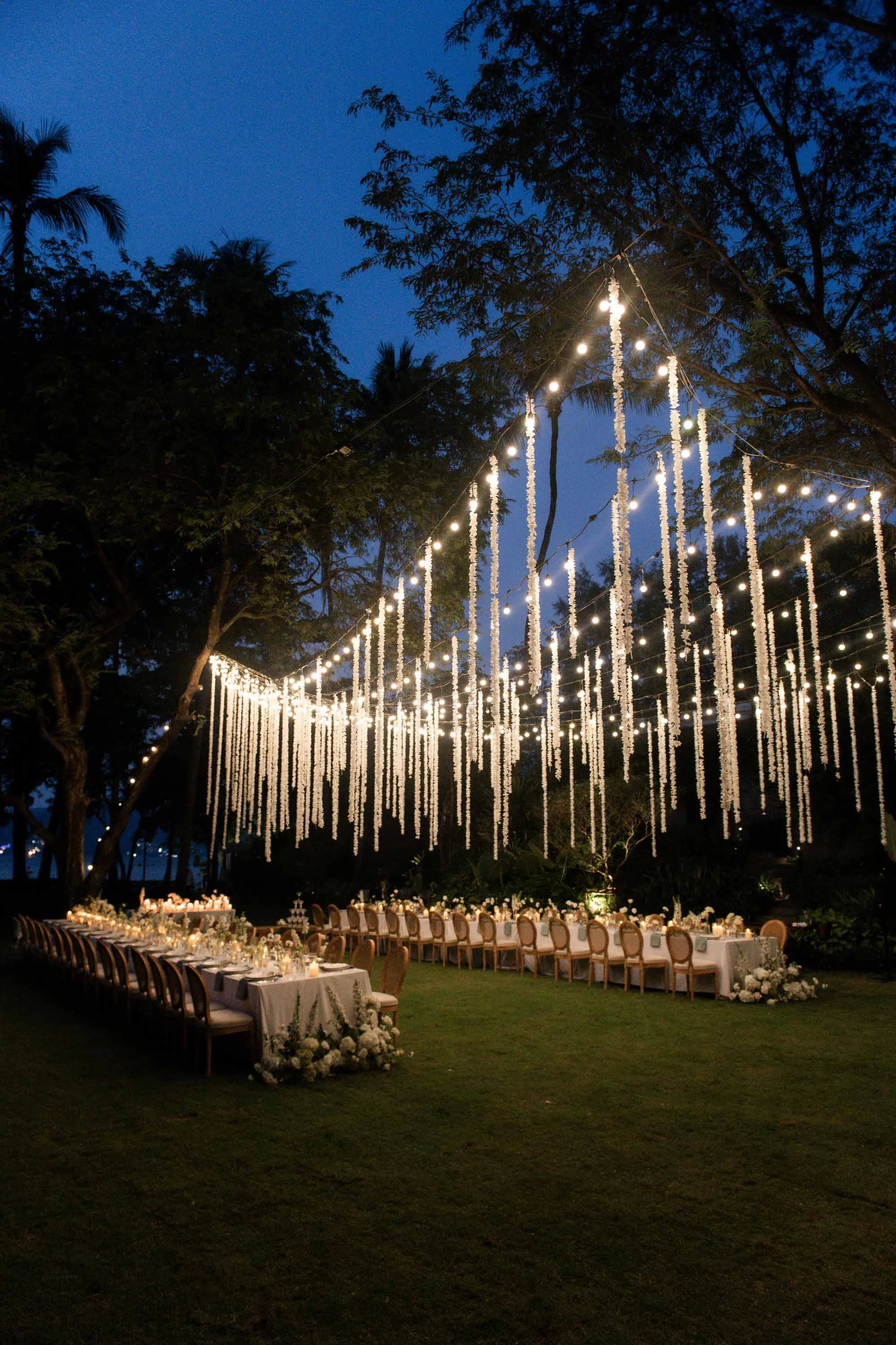 Outdoor dinner reception at Rosewood Phuket during twilight.