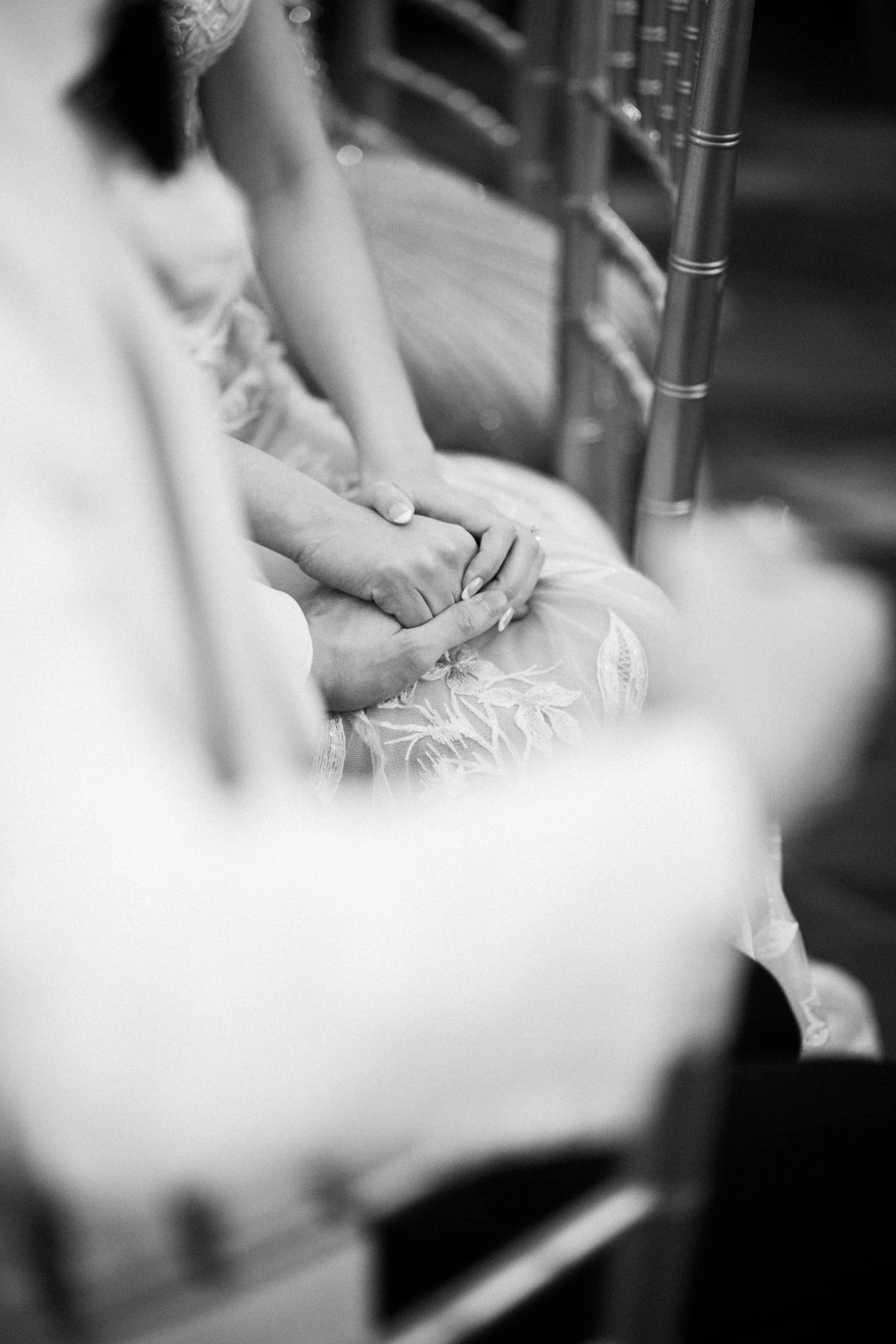 Bride and groom holding hands during the reception.