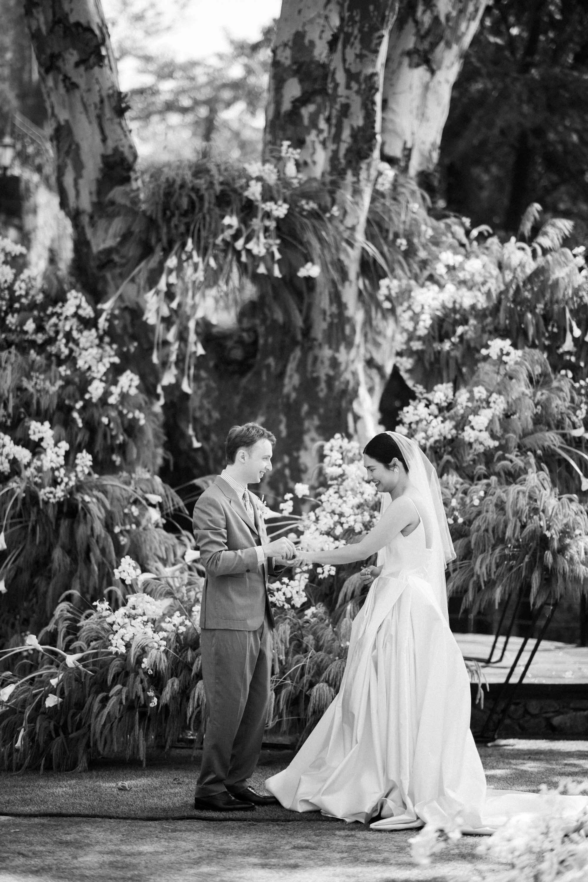 Bride and groom exchanging wedding rings during the ceremony.