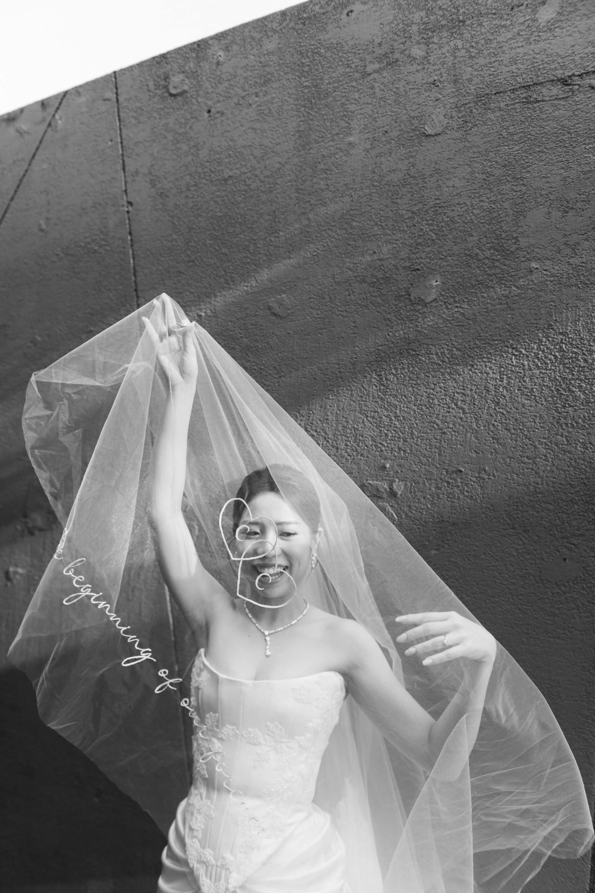 Bride playing with her veil before the ceremony.