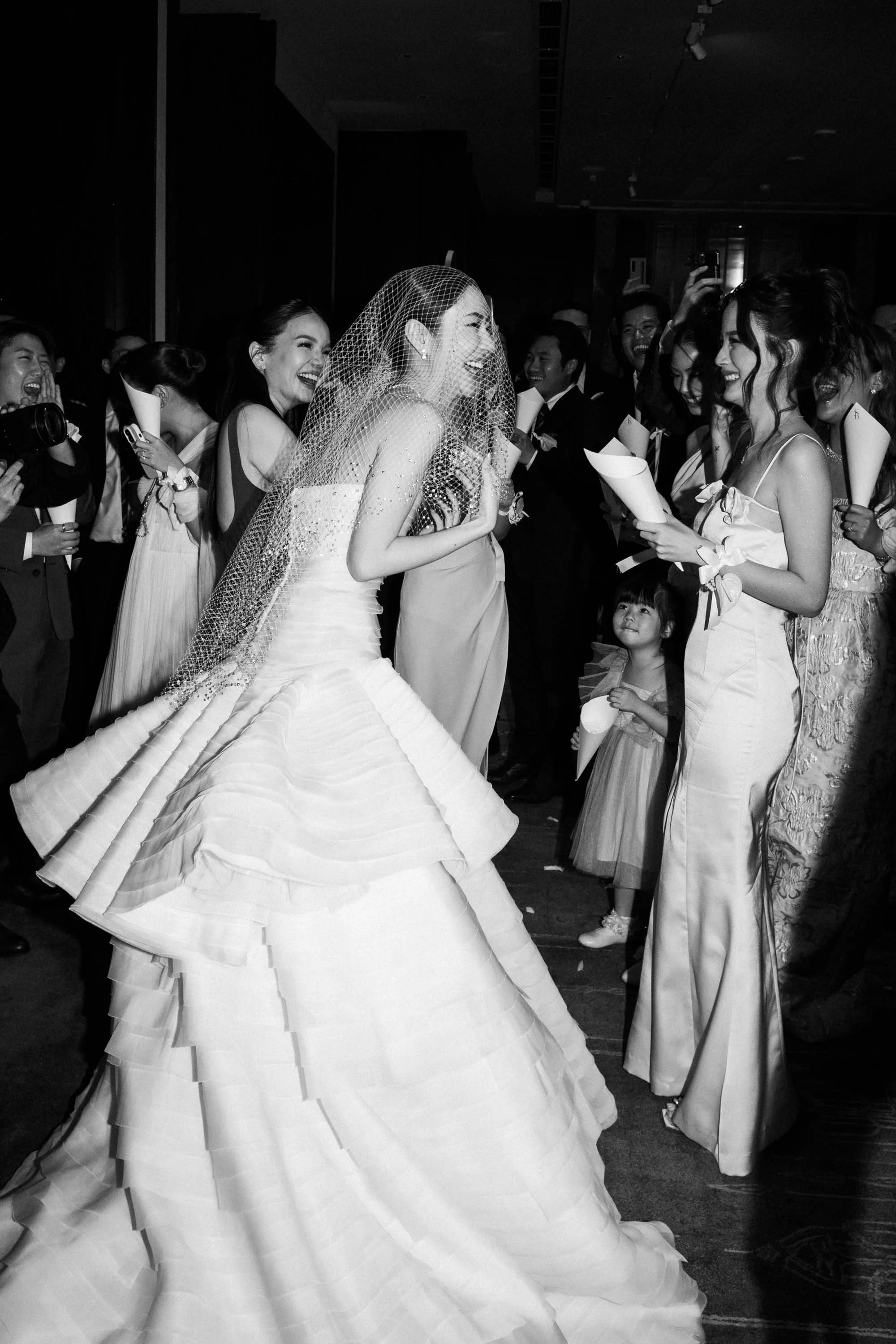 Friends gathering around the bride before the reception entrance.