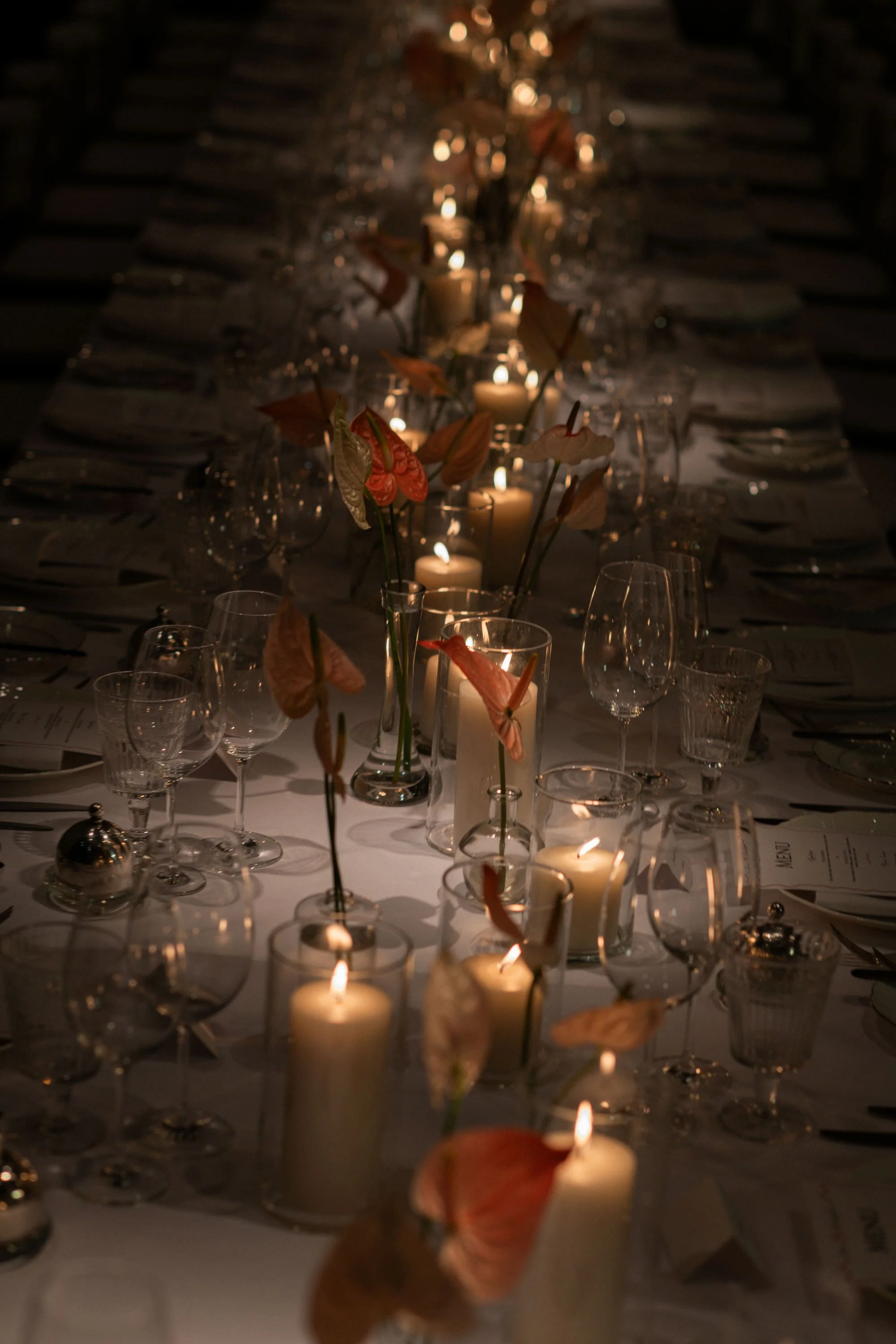 Floral centerpieces and candles decorating the reception table.