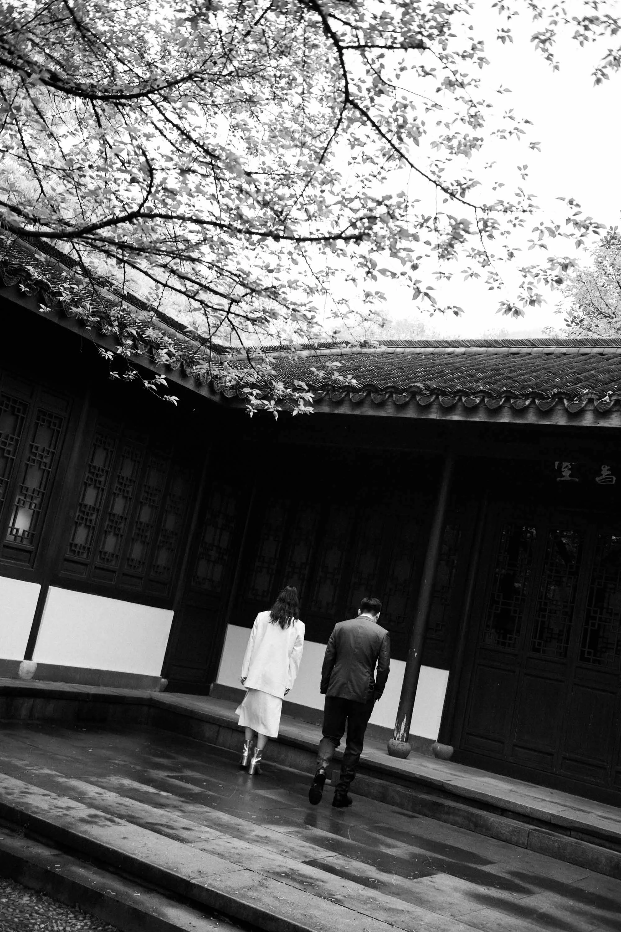 Bride and groom walking through the historic garden.