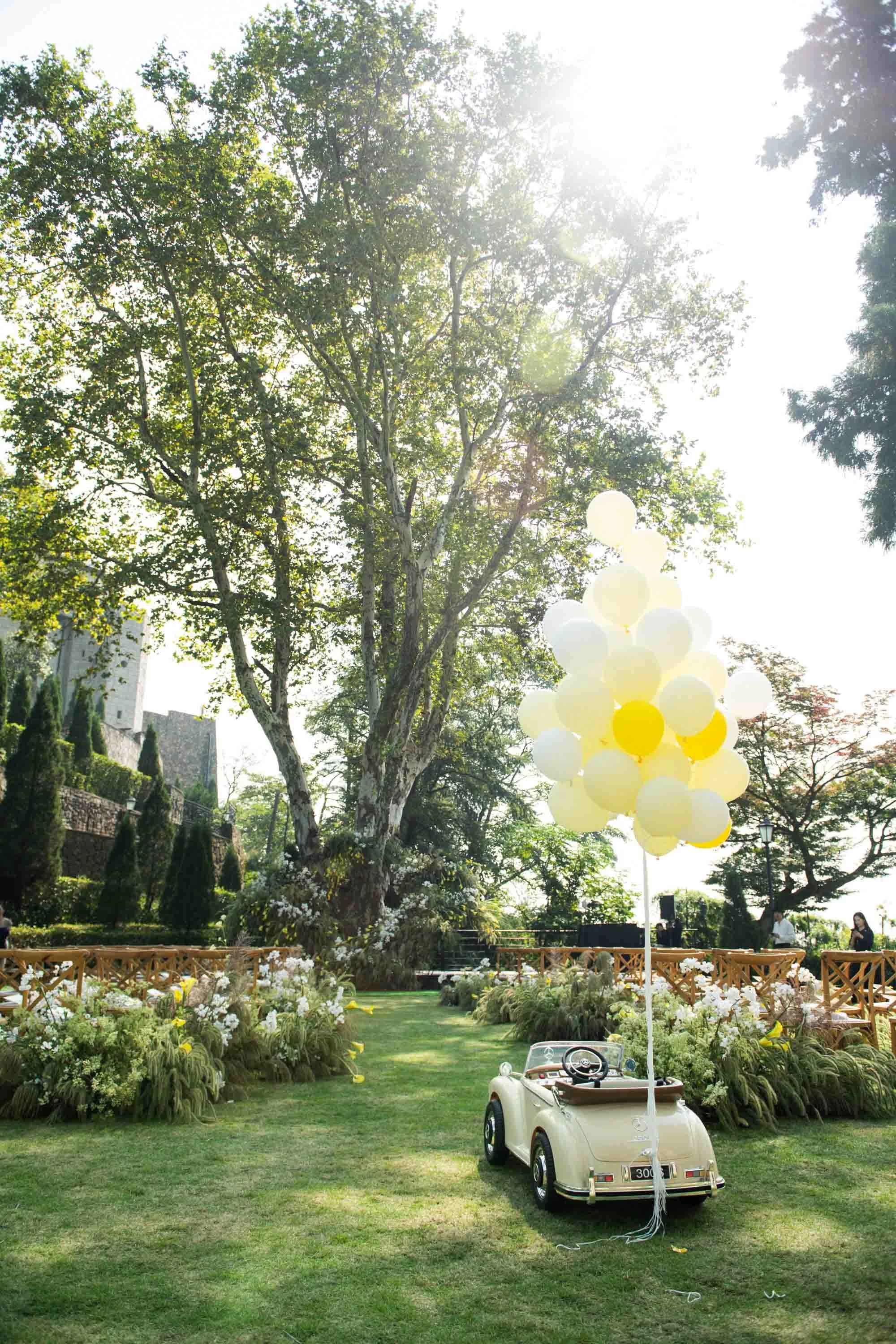 Outdoor ceremony setup beneath a large tree at Naked Castle Moganshan.