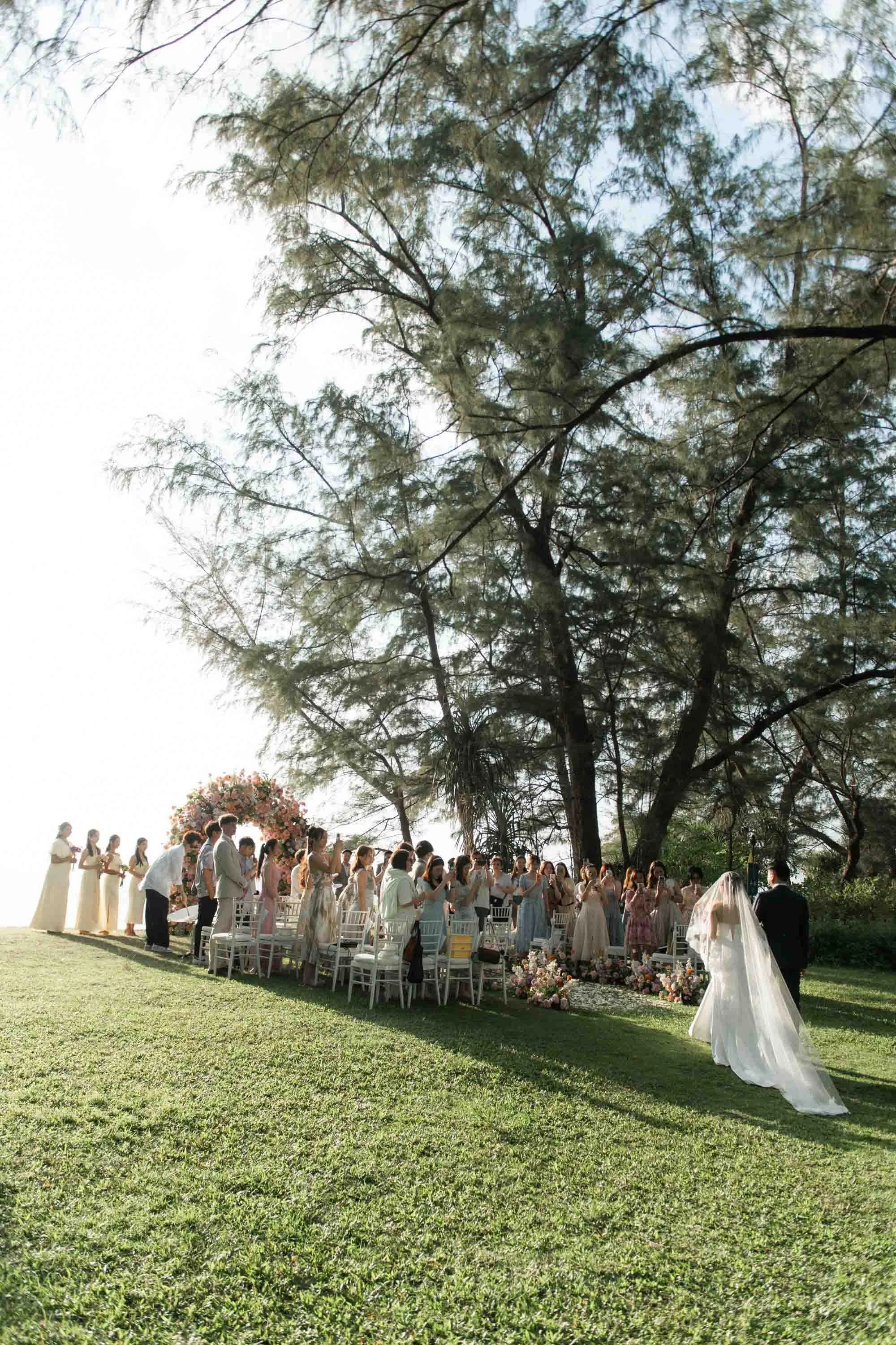 Bride walking down the aisle with her father during the ceremony.