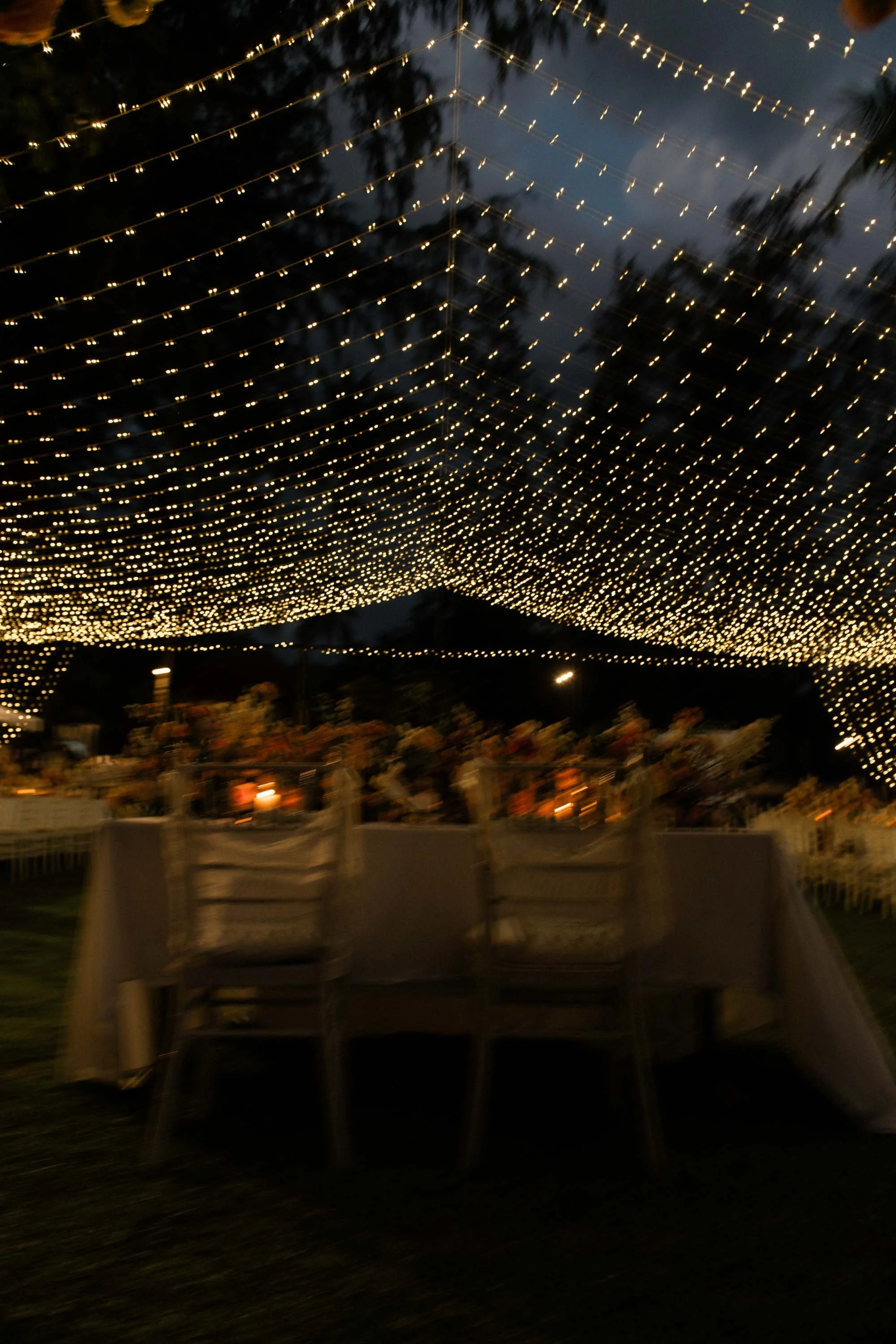 Outdoor dinner reception beneath string lights at Renaissance Phuket.