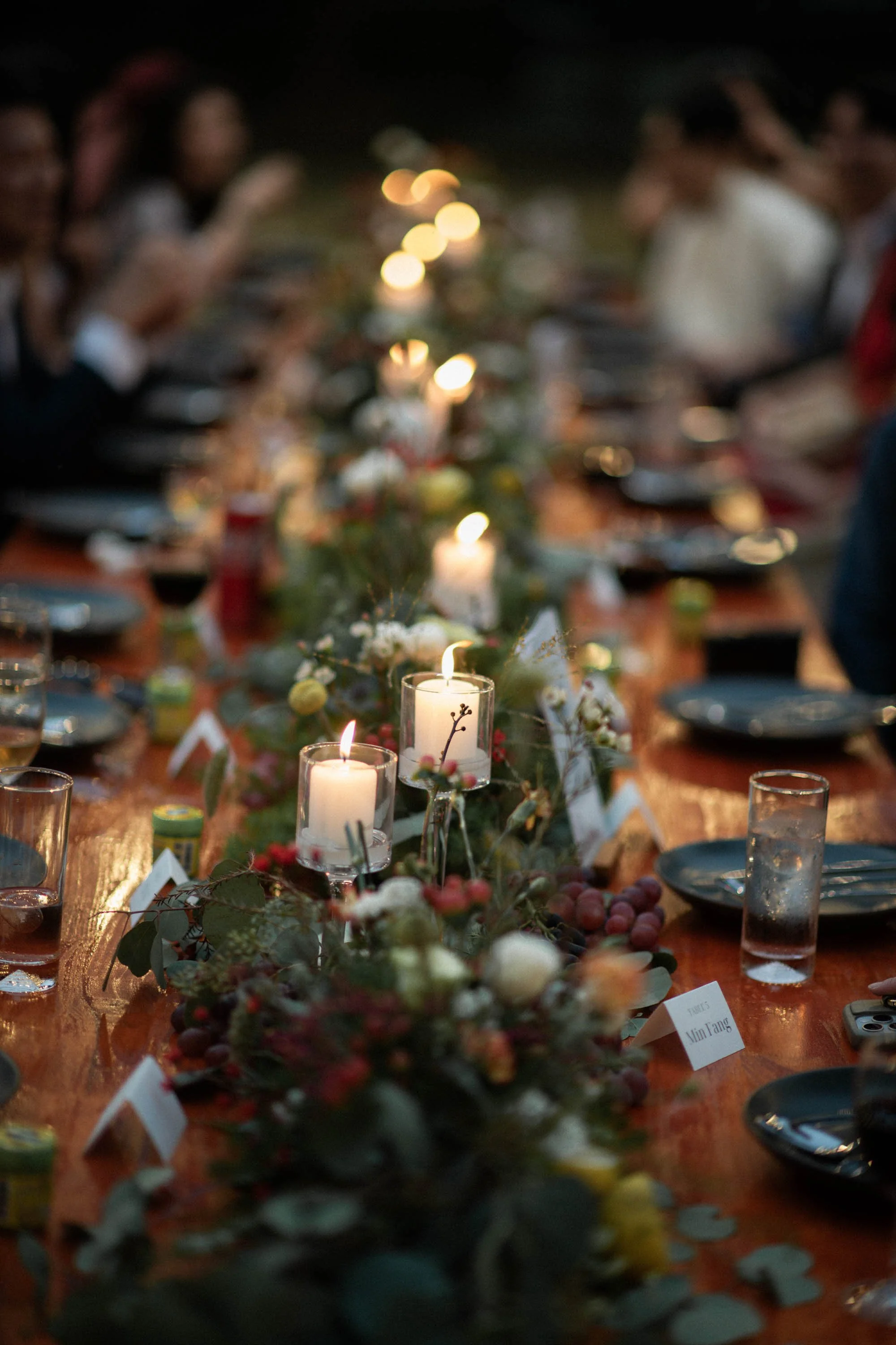 Candles and floral centerpieces decorating the reception table.