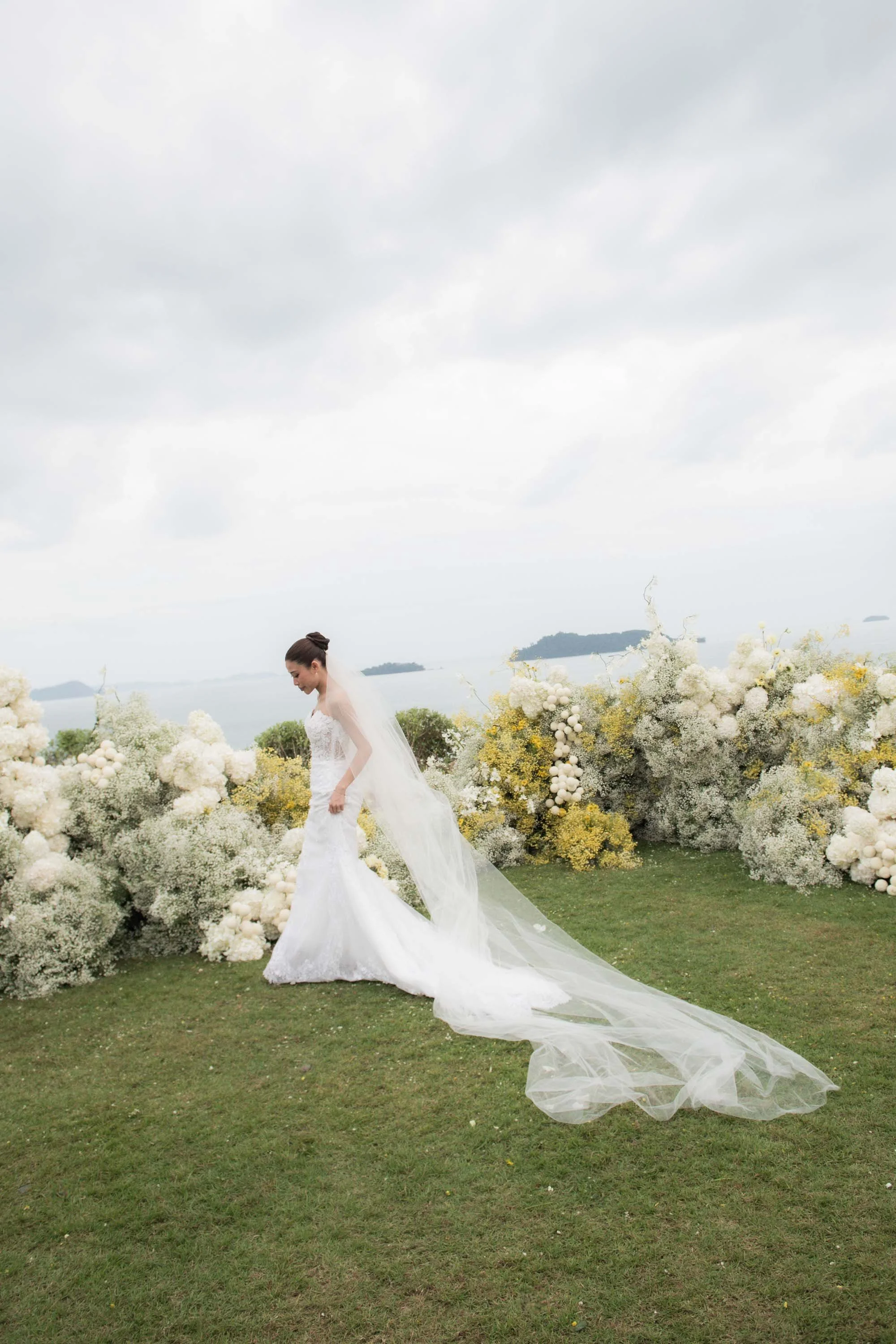Bride posing among the floral ceremony decorations.
