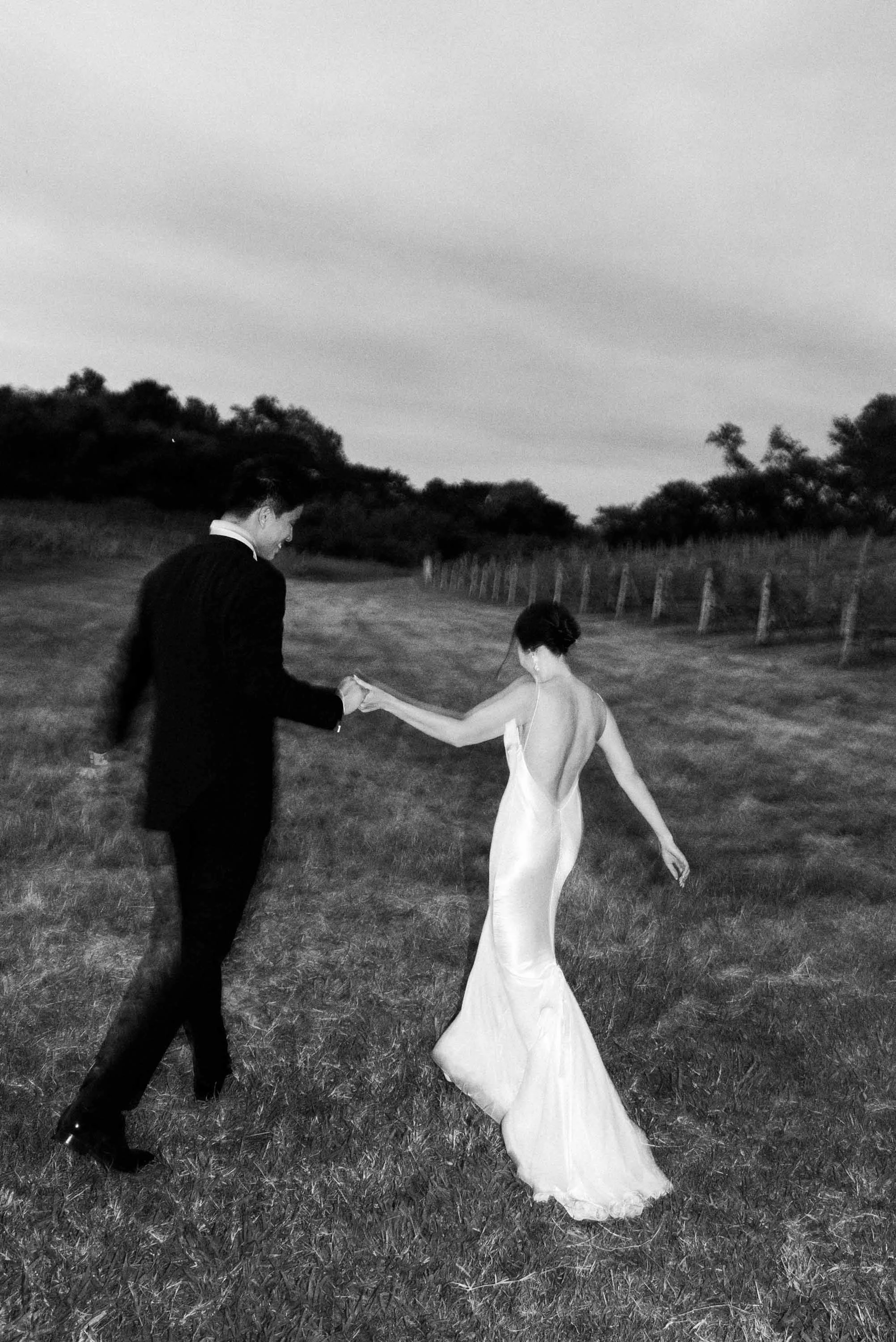 Bride and groom taking portraits together while waiting for dinner to begin.