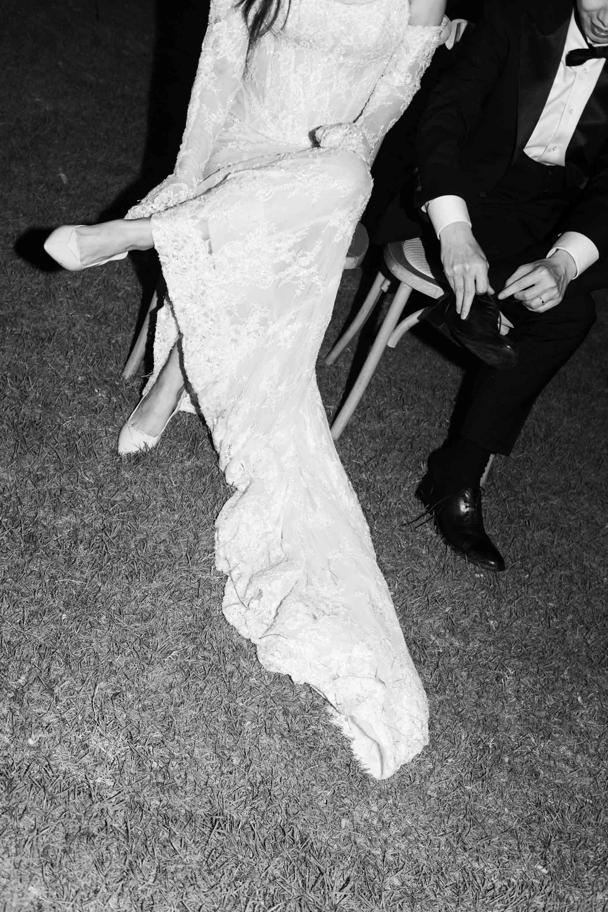 Bride and groom putting their shoes back on after a wedding game.