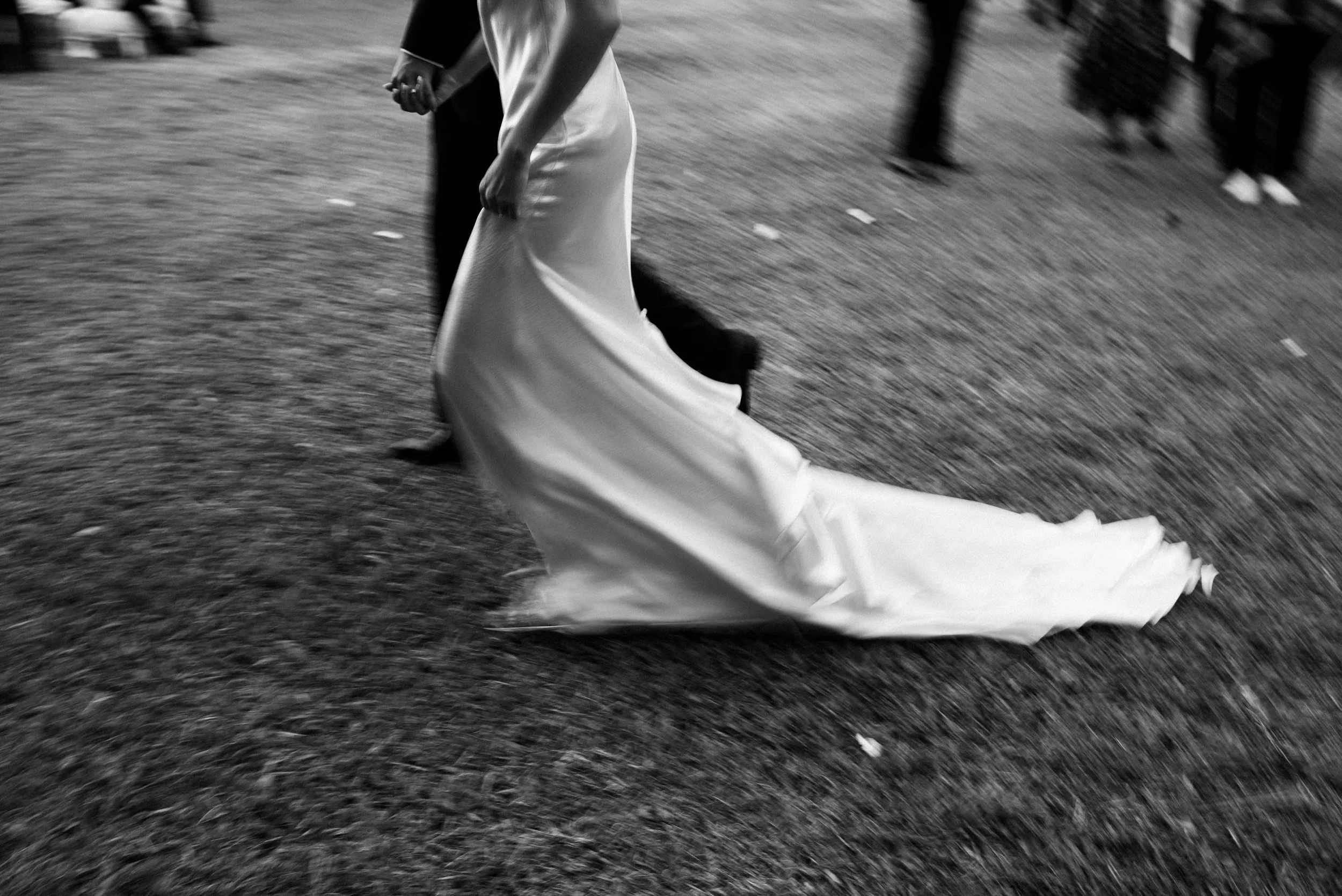 Bride and groom walking away together after their vows.