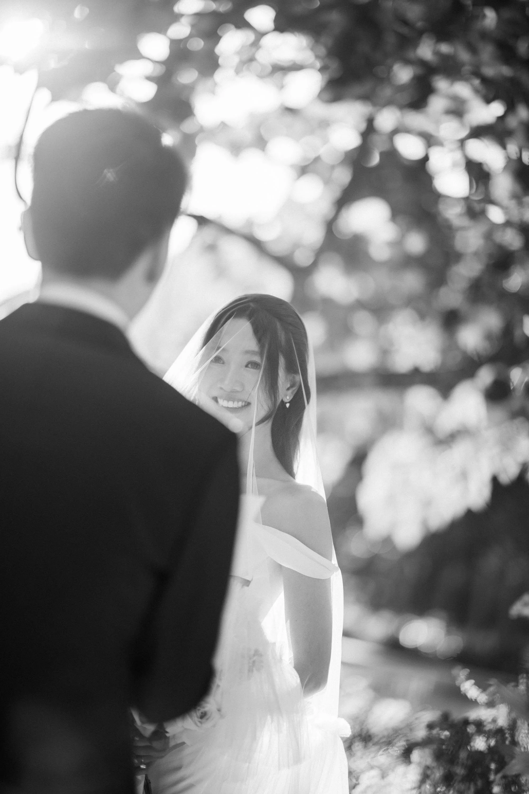 Bride smiling while listening to the groom during the wedding vows.