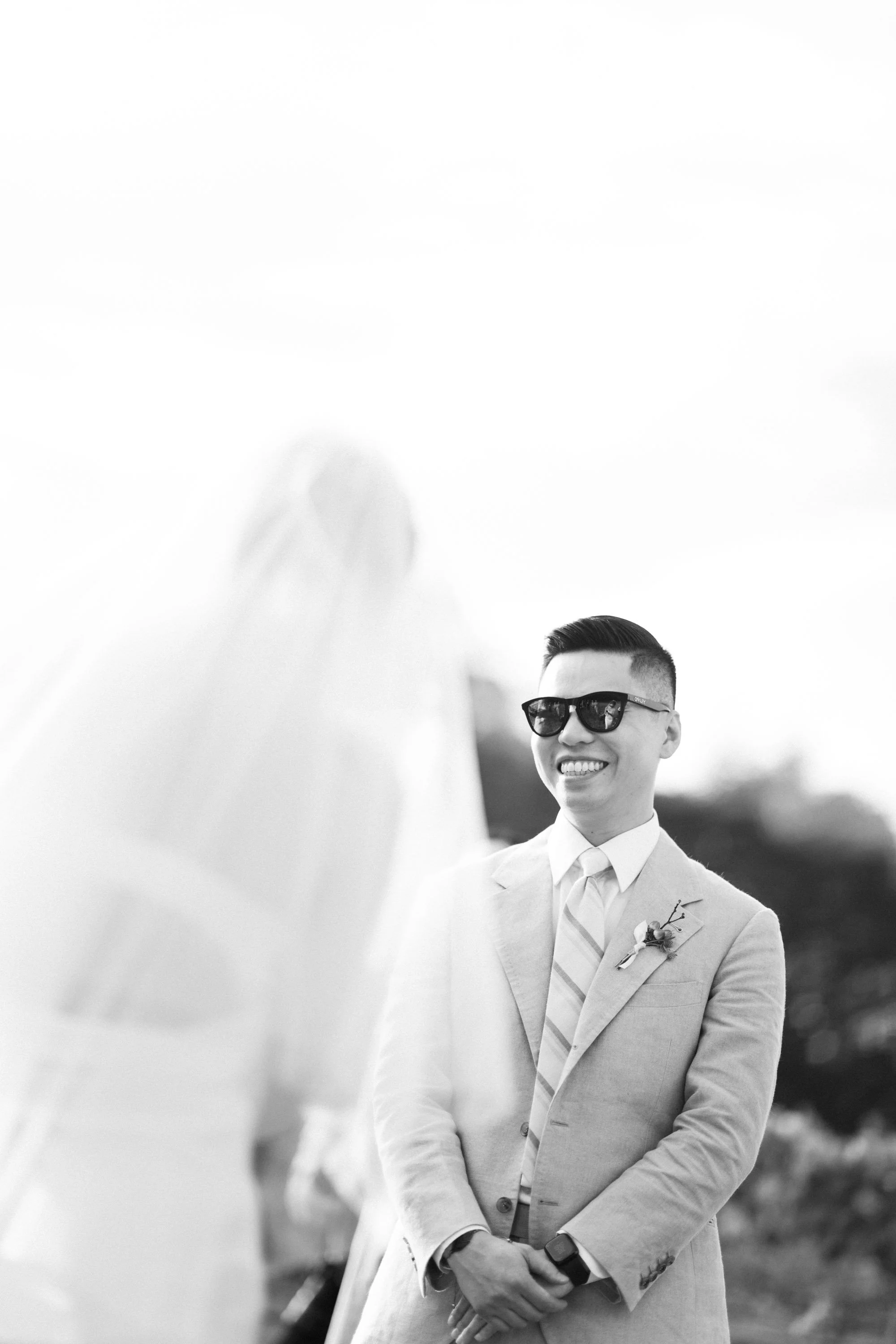 Groom smiling while listening to the bride during the wedding vows.