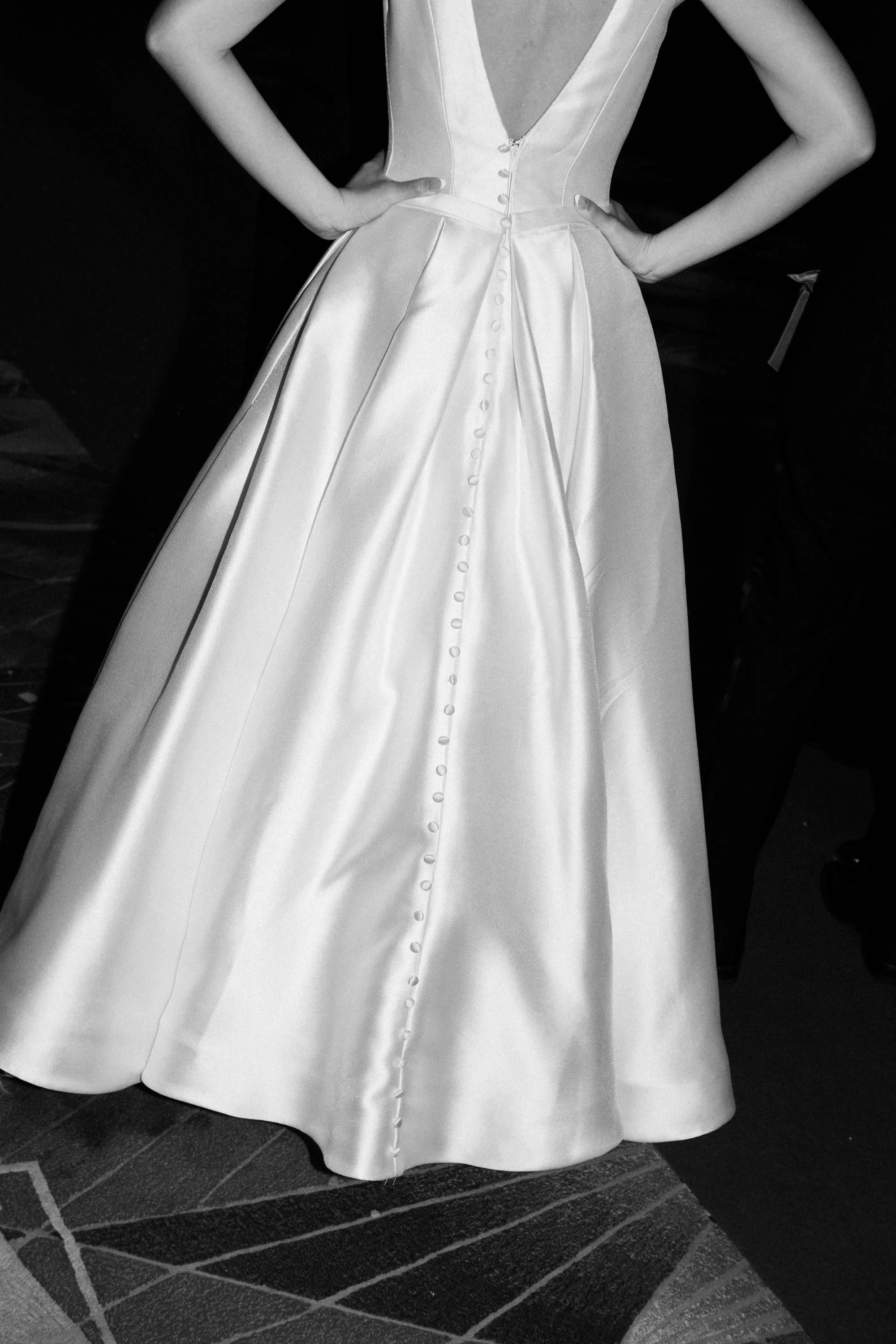 Bride wearing a white satin wedding dress.