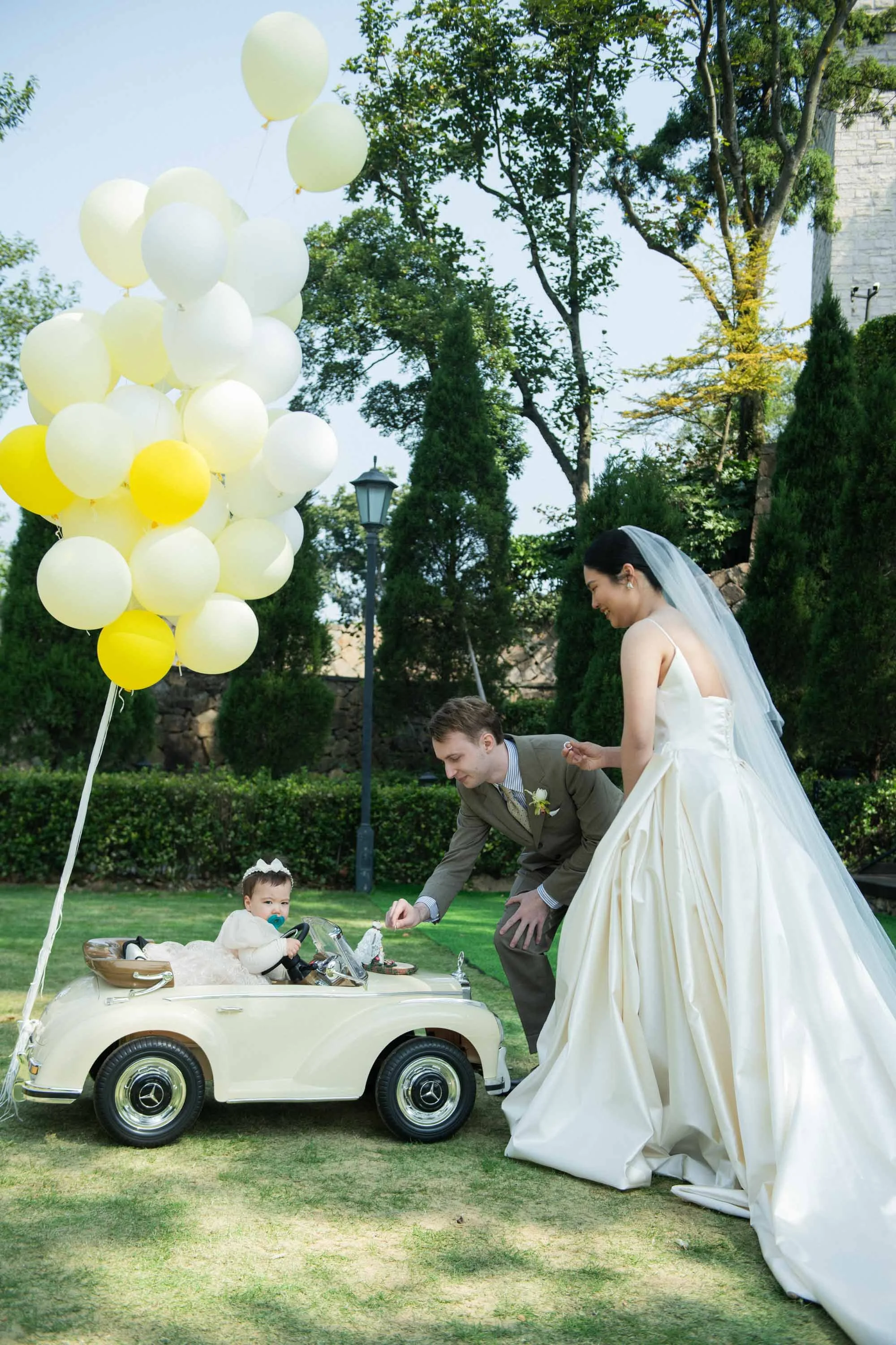 Bride and groom taking the wedding rings from the toy car.