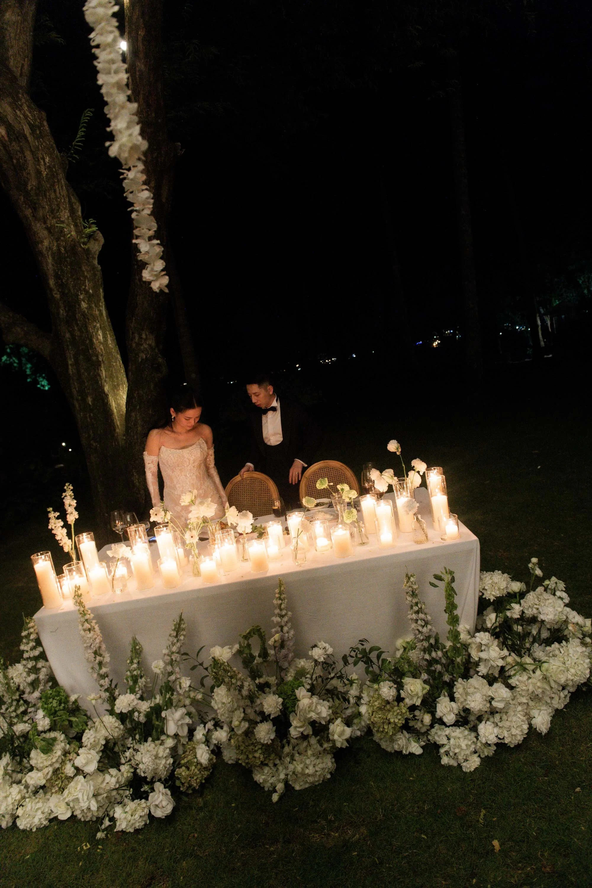 Groom helping the bride with her chair during the reception.