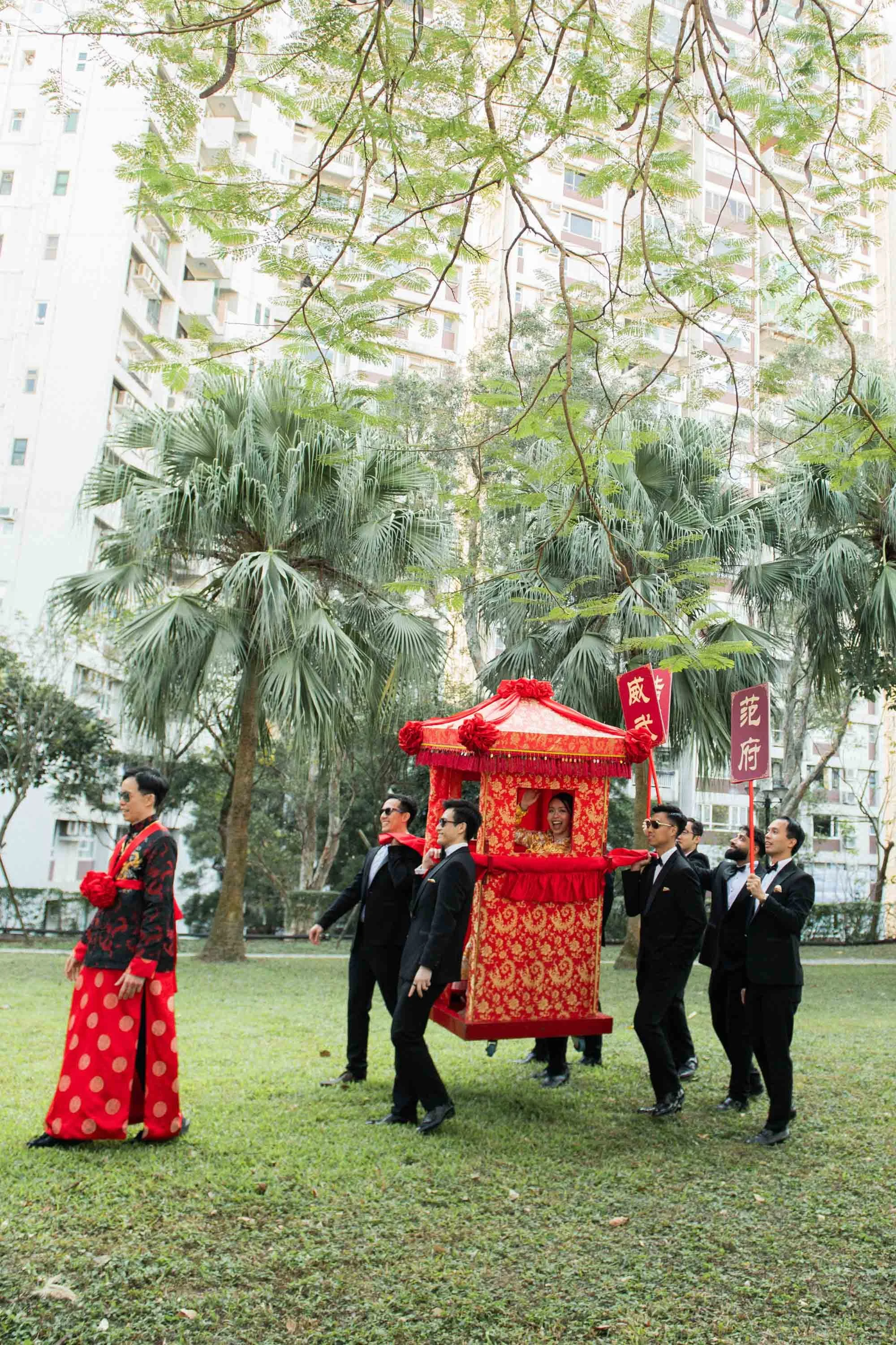 Groom and friends carrying the bridal sedan chair.