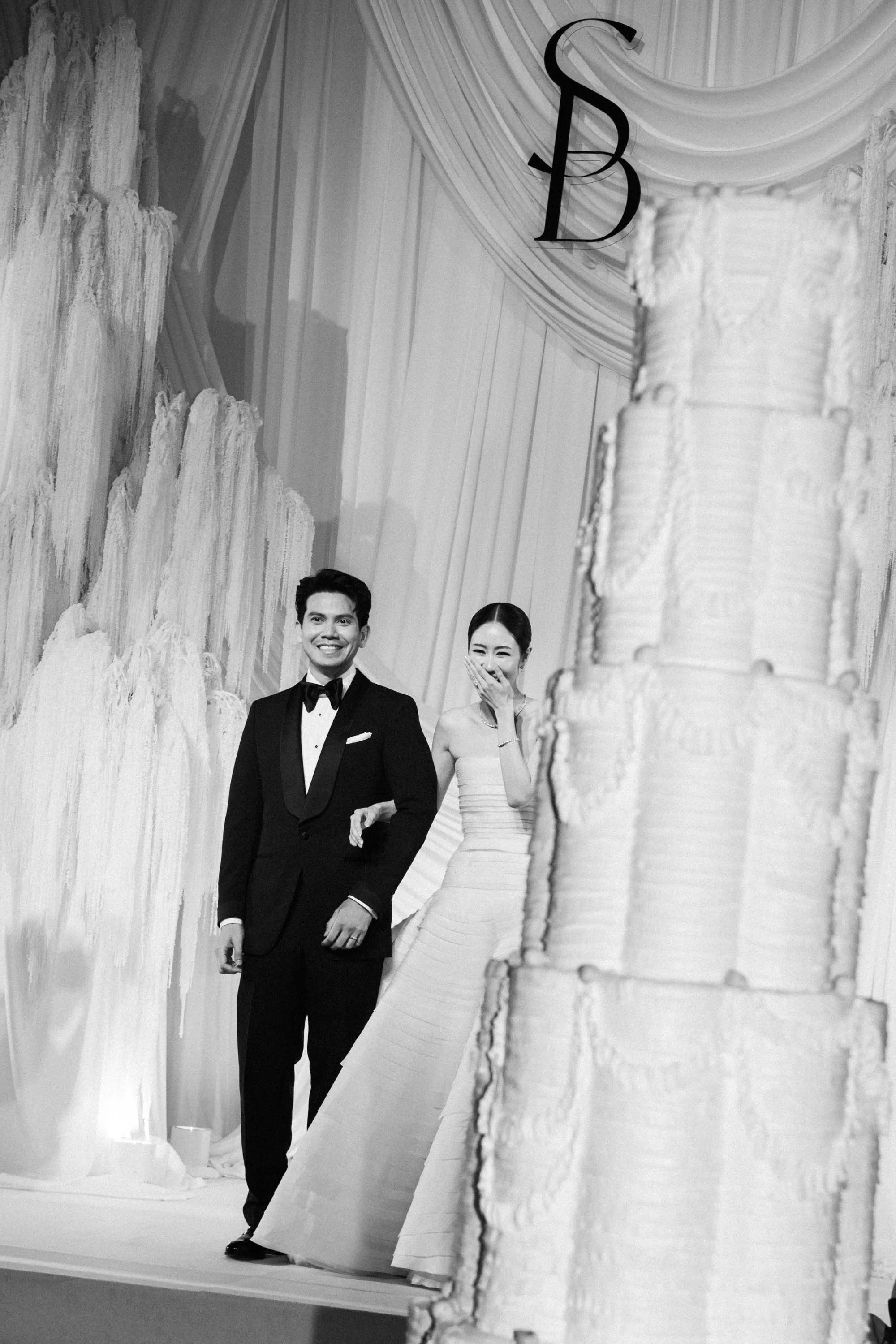 Bride and groom watching the wedding cake arrive during the reception.