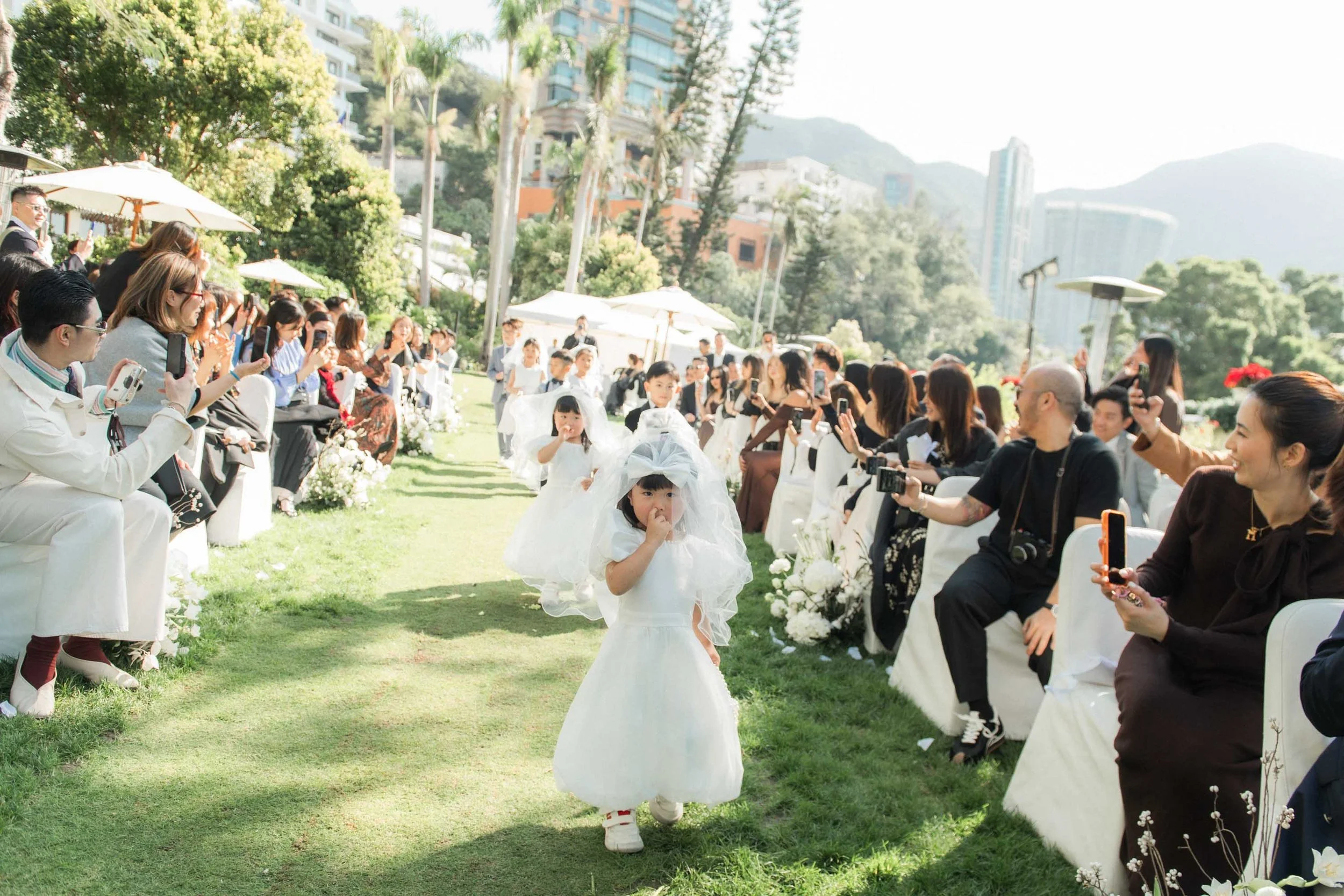 Flower children walking down the aisle before the ceremony.