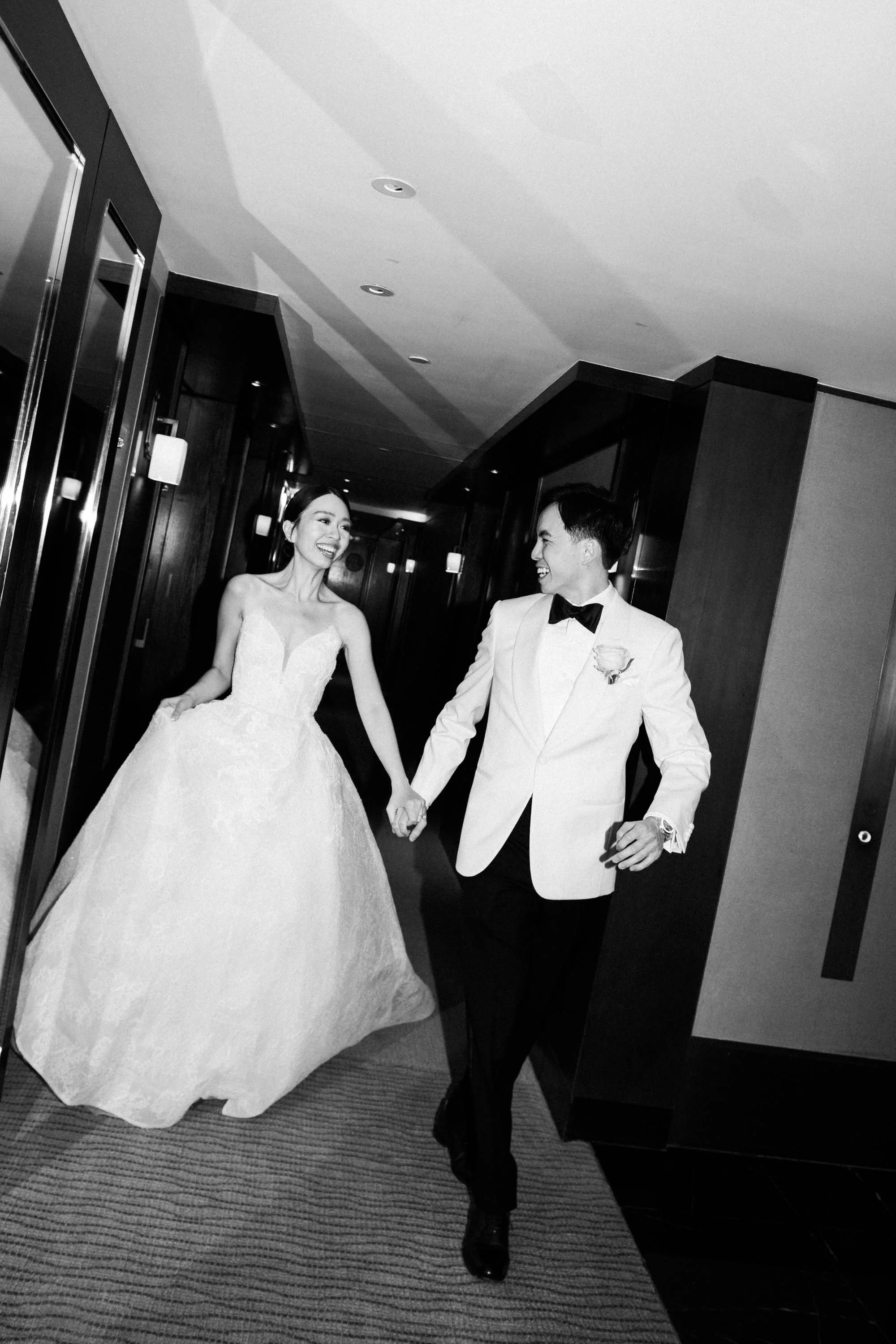 Bride and groom walking through the hotel before the ceremony.