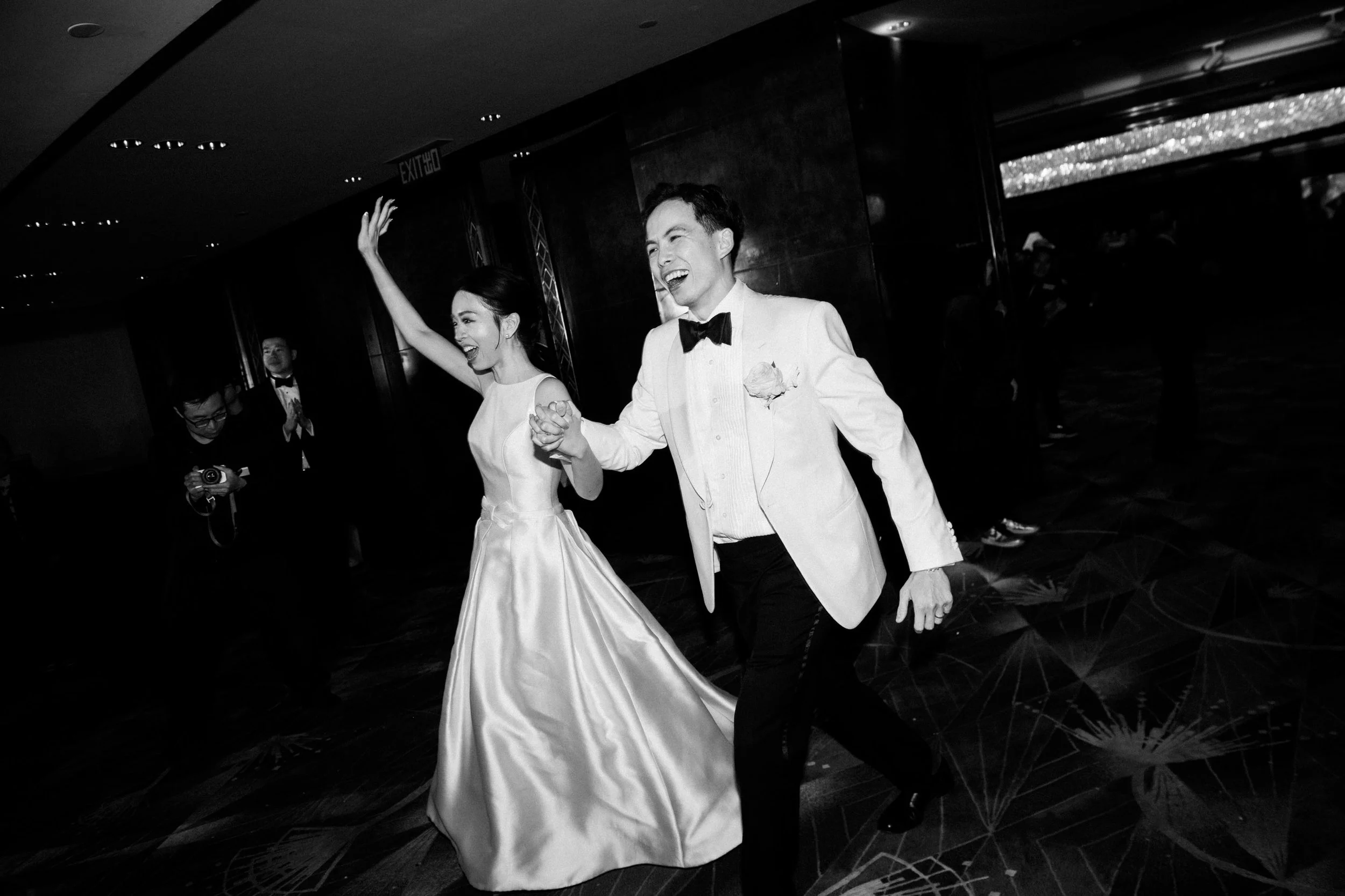 Bride and groom running into the reception together.