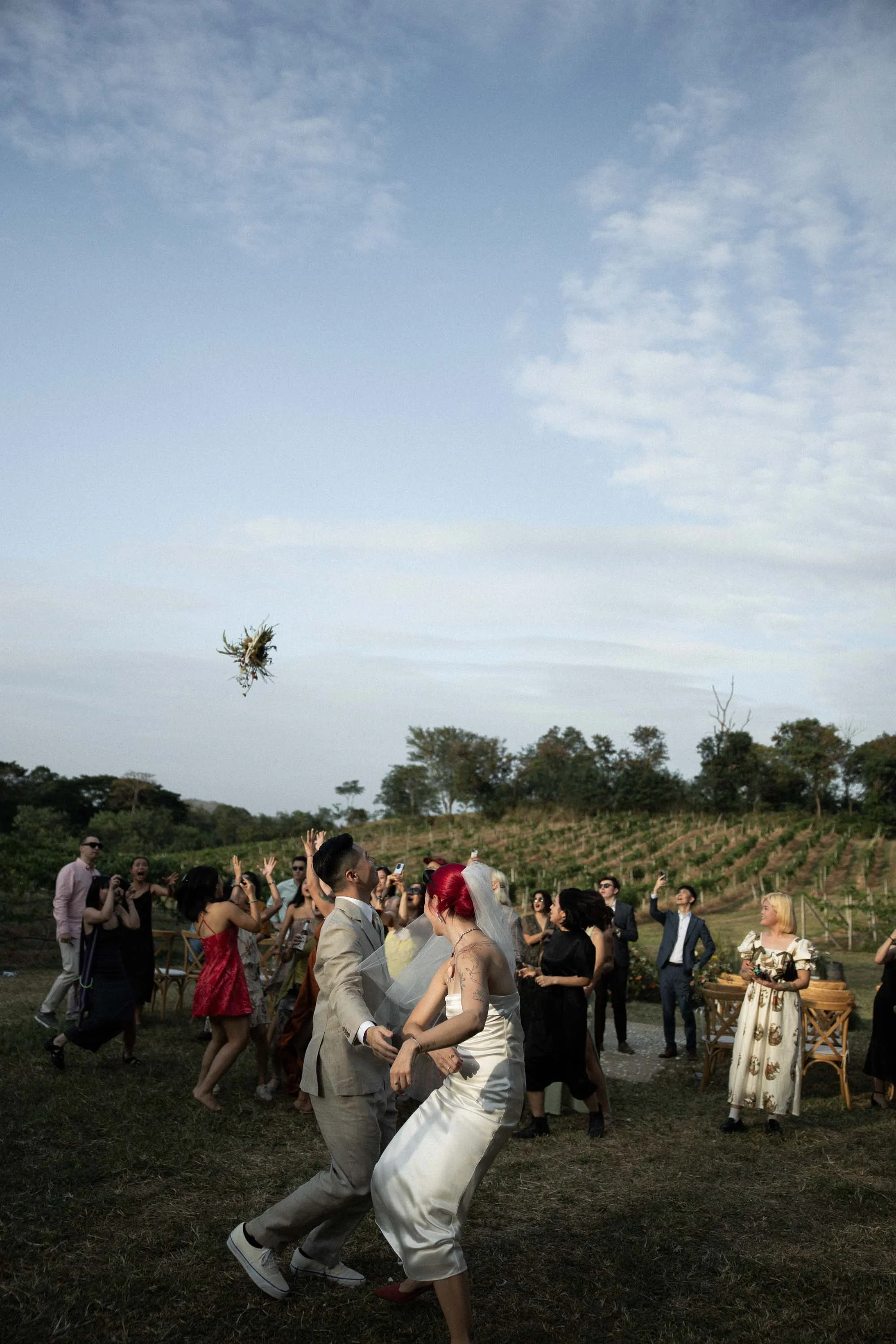 Bride tossing her bouquet to the guests.