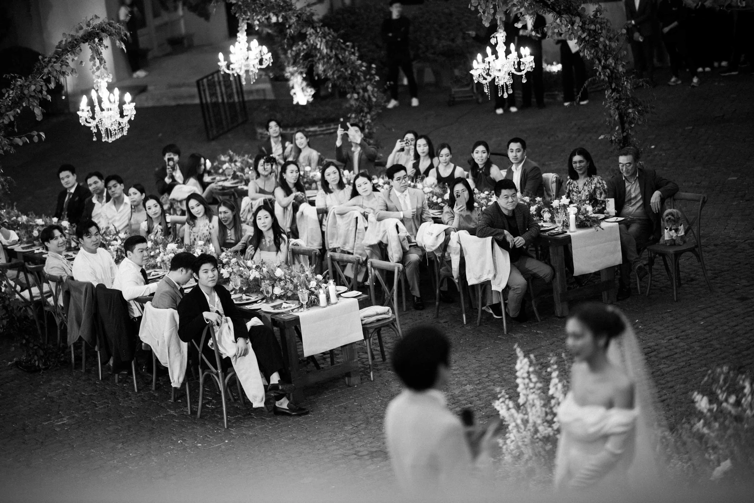 Bride and groom sharing personal vows with their guests around the dinner tables.