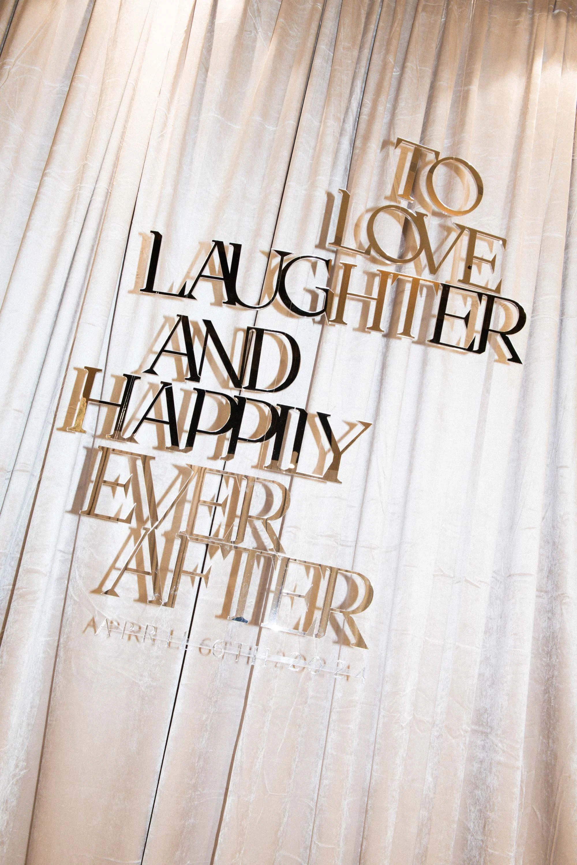 Wedding backdrop with the couple’s celebration message.
