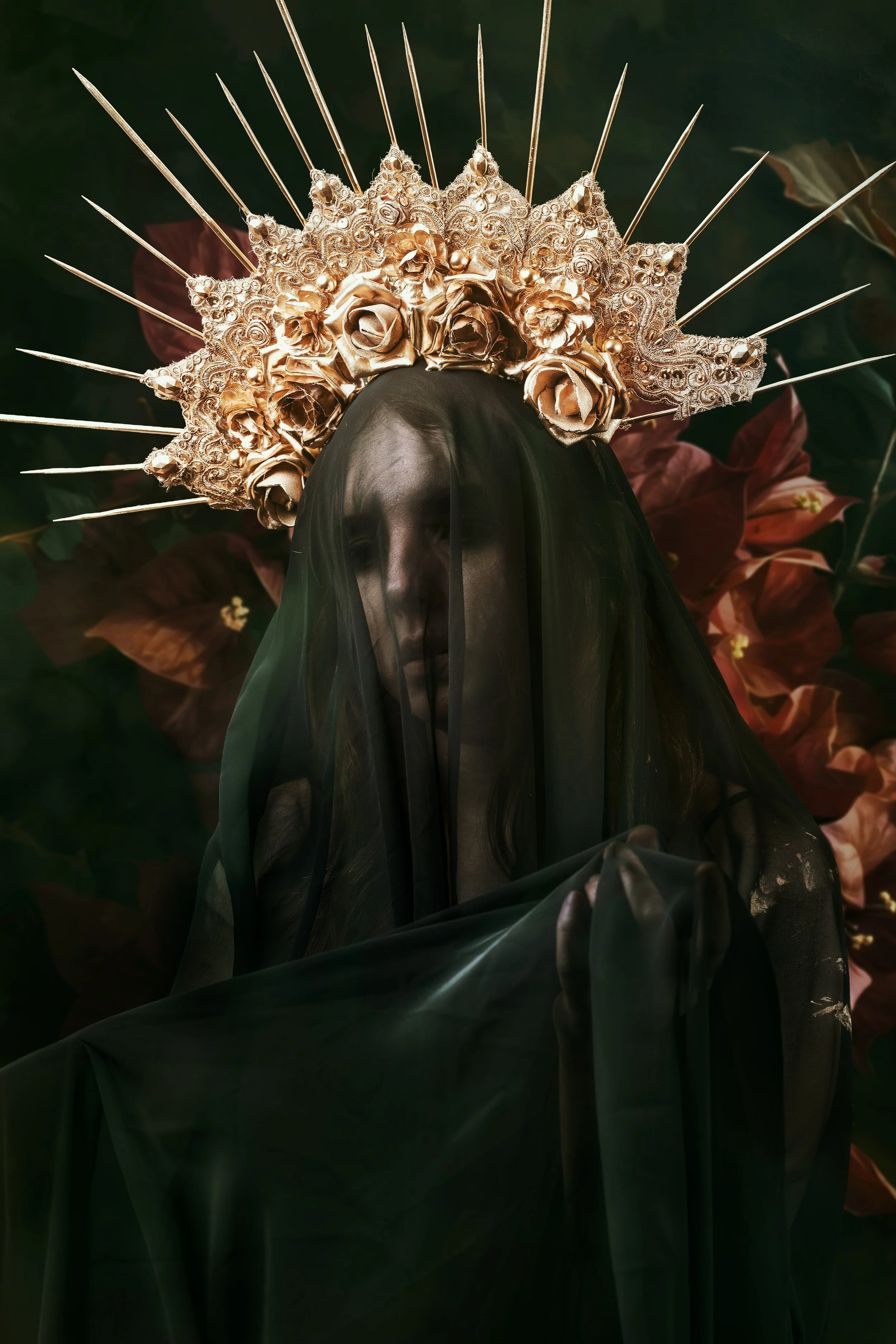 Fine art portrait of a veiled woman beneath an ornate gold crown with roses and radiant spikes against a dark floral background.