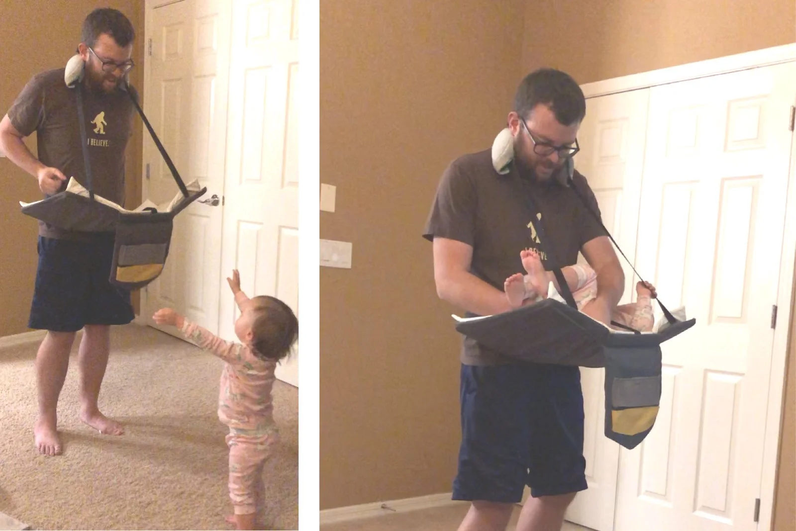 A man with glasses and a beard is carrying a baby in a hanging infant sling, while a young girl reaching upward interacts with him. They are indoors in a room with beige walls and a closed white door.