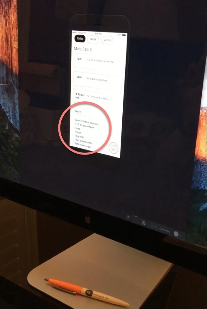 Smartphone displaying a checklist on a calendar app, paired with a white and orange pen on a desk.