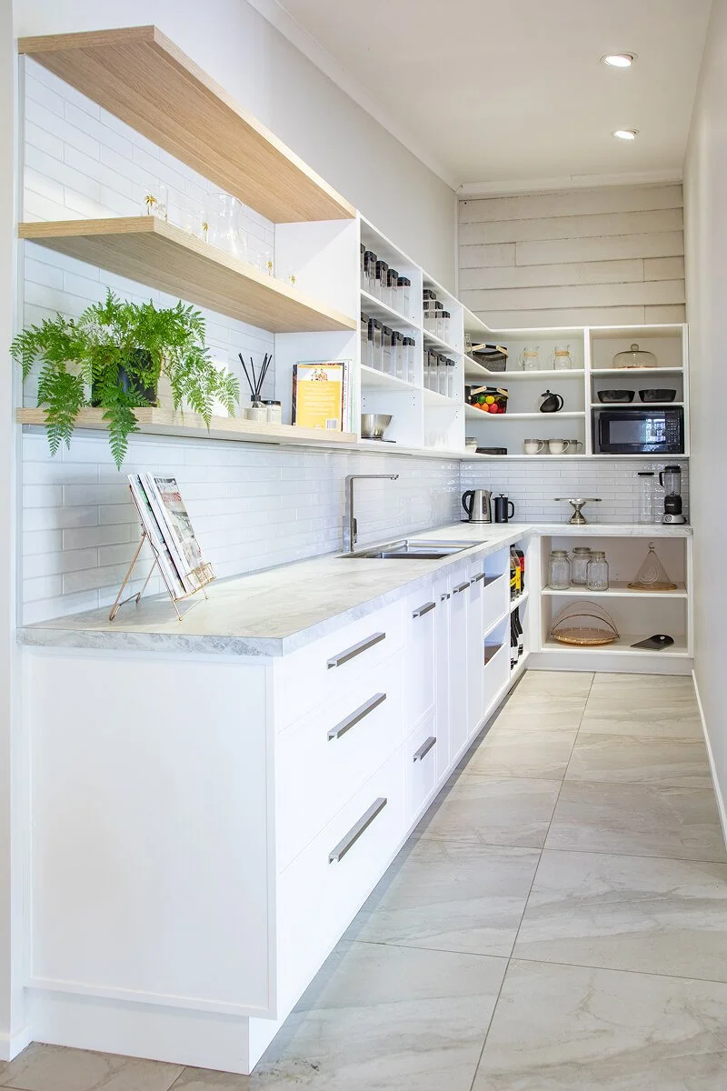 Bespoke scullery with open shelving, drawers and generous bench space.