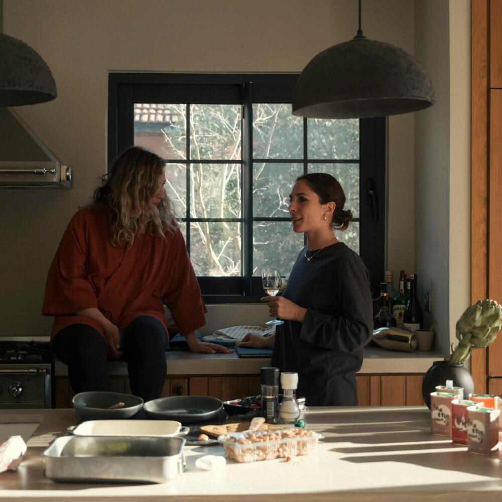 Two women talking in a Carrolls kitchen.