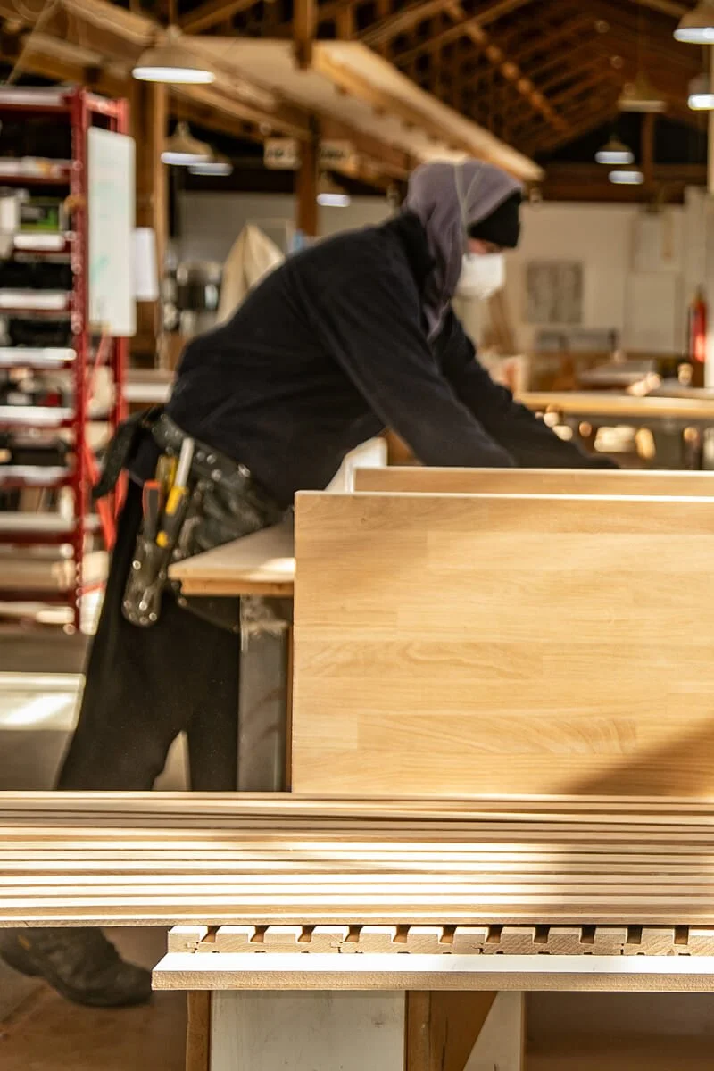 Carrolls craftsperson working on timber cabinetry in the workshop.