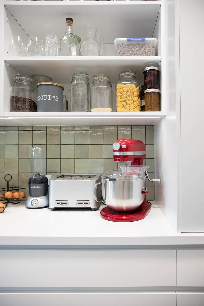 Scullery worktop with open shelving for dry goods and small appliances.
