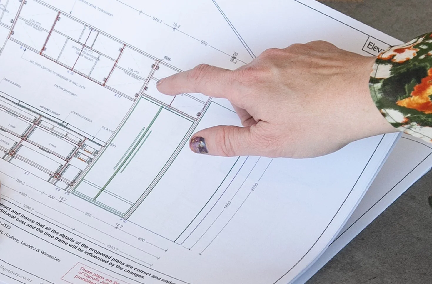 Carrolls designer reviewing detailed joinery plans.