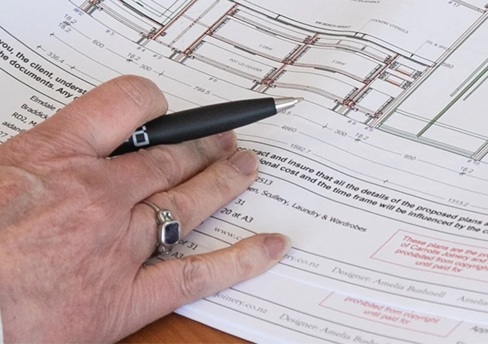Close-up of joinery plans being reviewed during the design process.