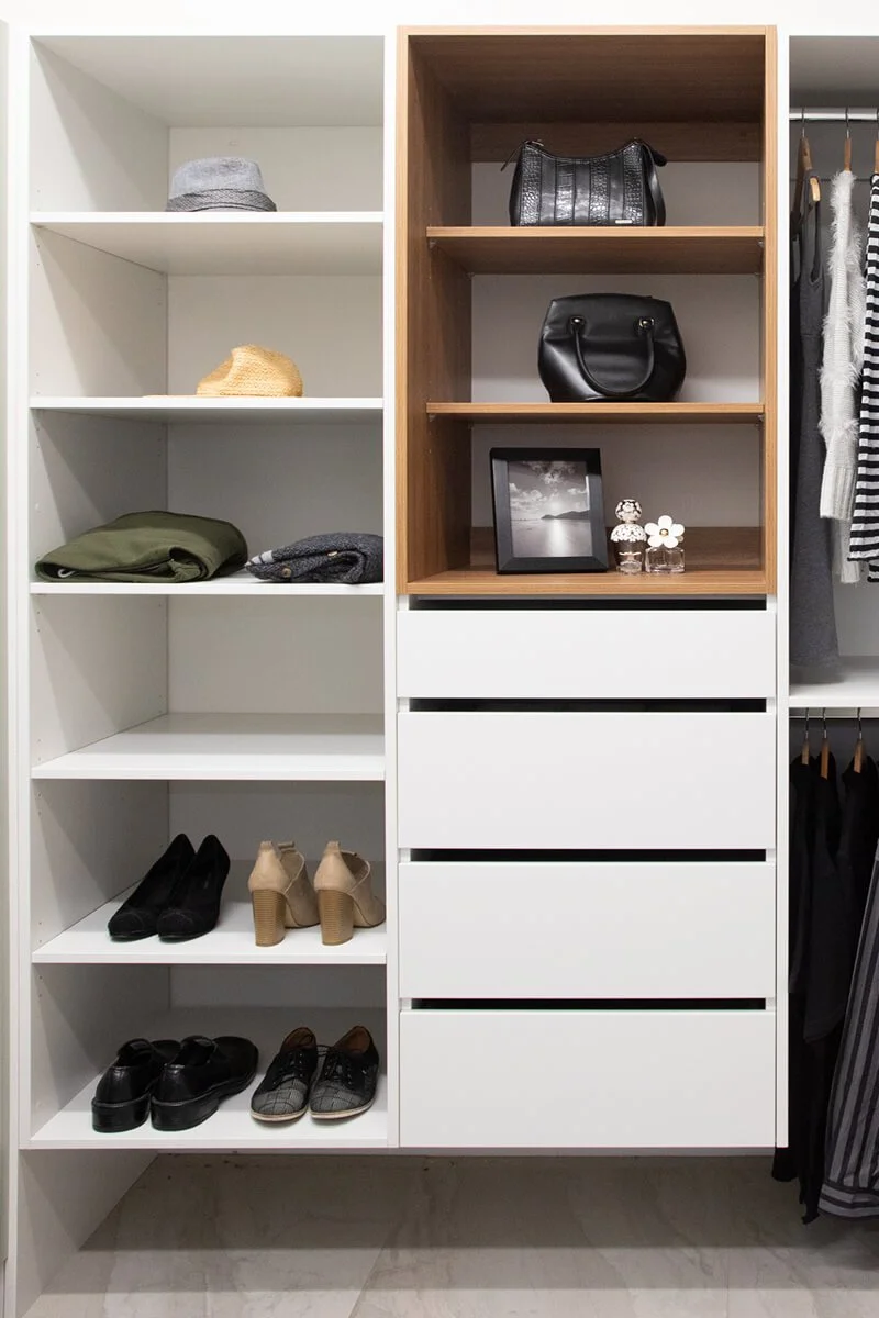 Bespoke wardrobe with open shelving, drawers, shoe storage and hanging space.