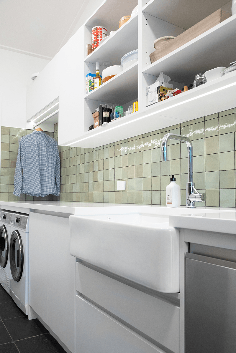 White laundry with open shelving, deep sink and integrated hanging rail.