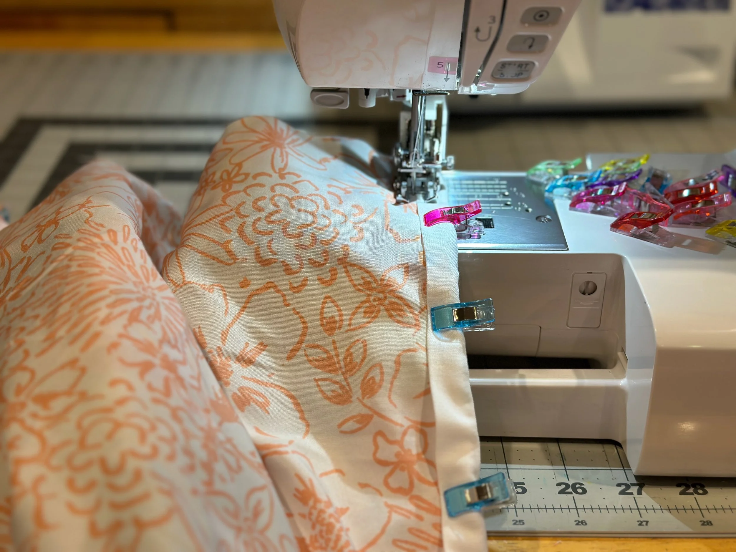A quilted jacket in progress being sewn 
on a sewing machine at Nicollet's Place 
handmade studio in Altadena, California.