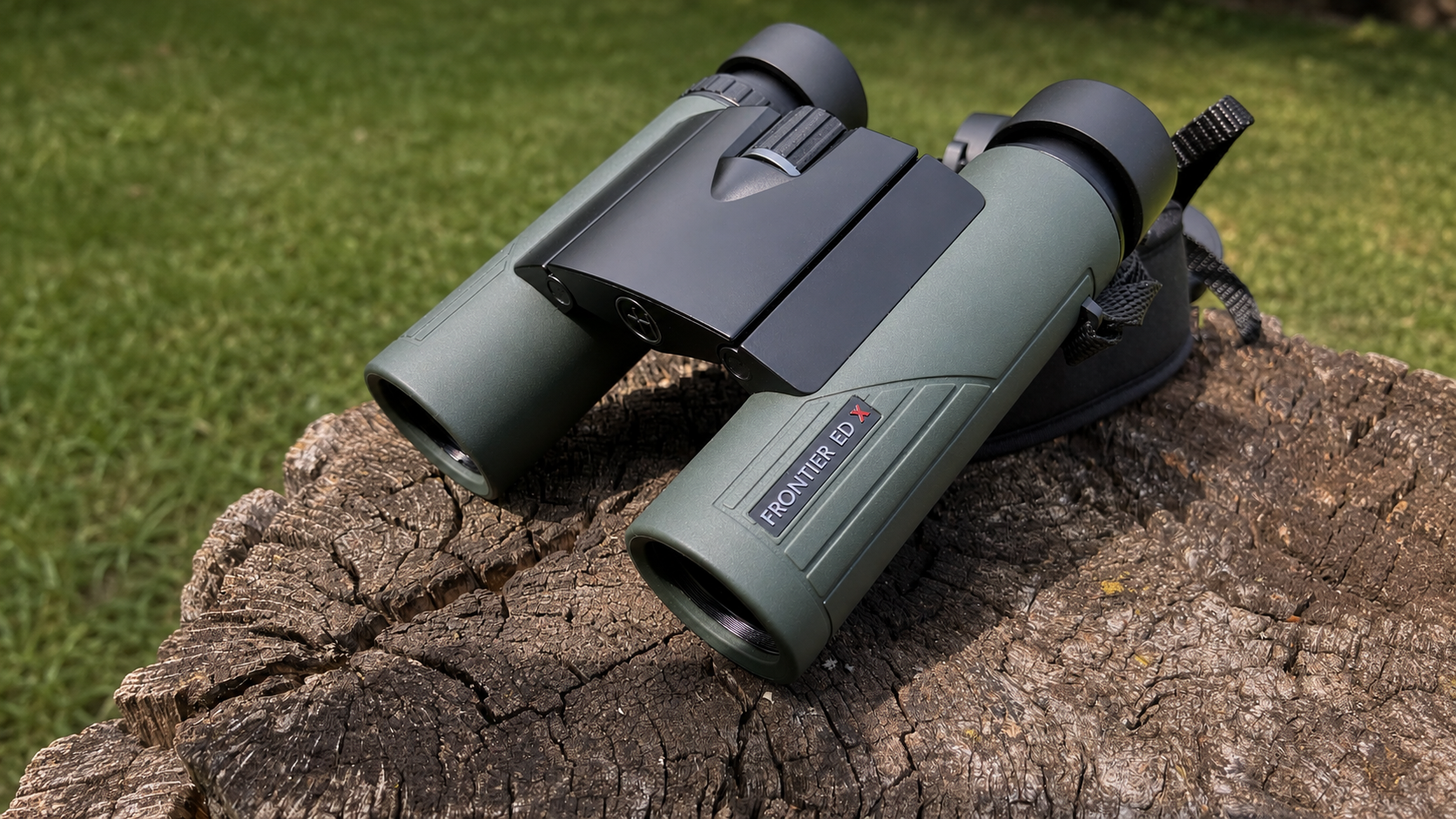 Green Hawke Frontier ED X 8×25 compact binoculars opened on a neutral field surface.