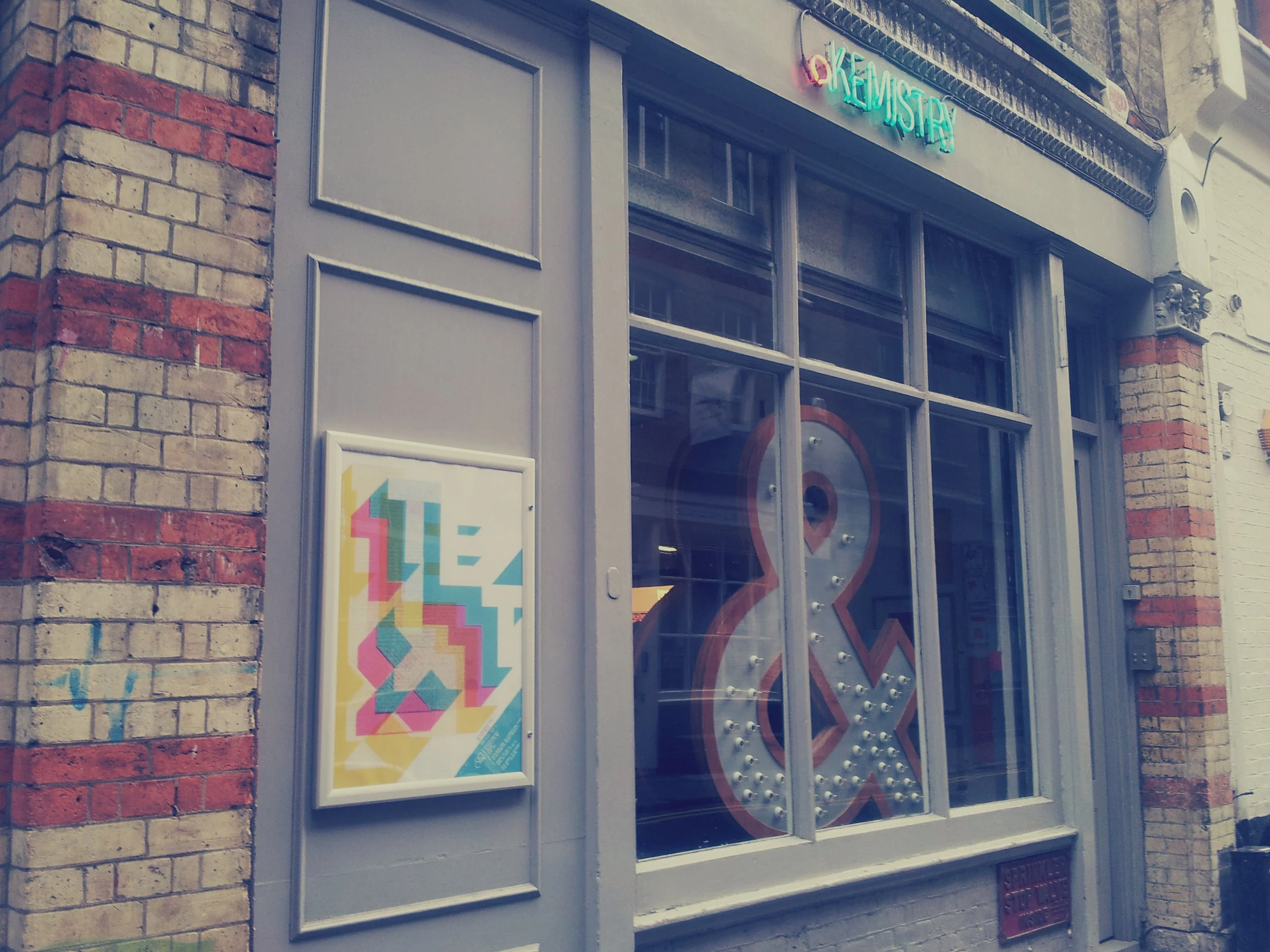 Exterior of a Kemitry Gallery with Text exhibition poster.