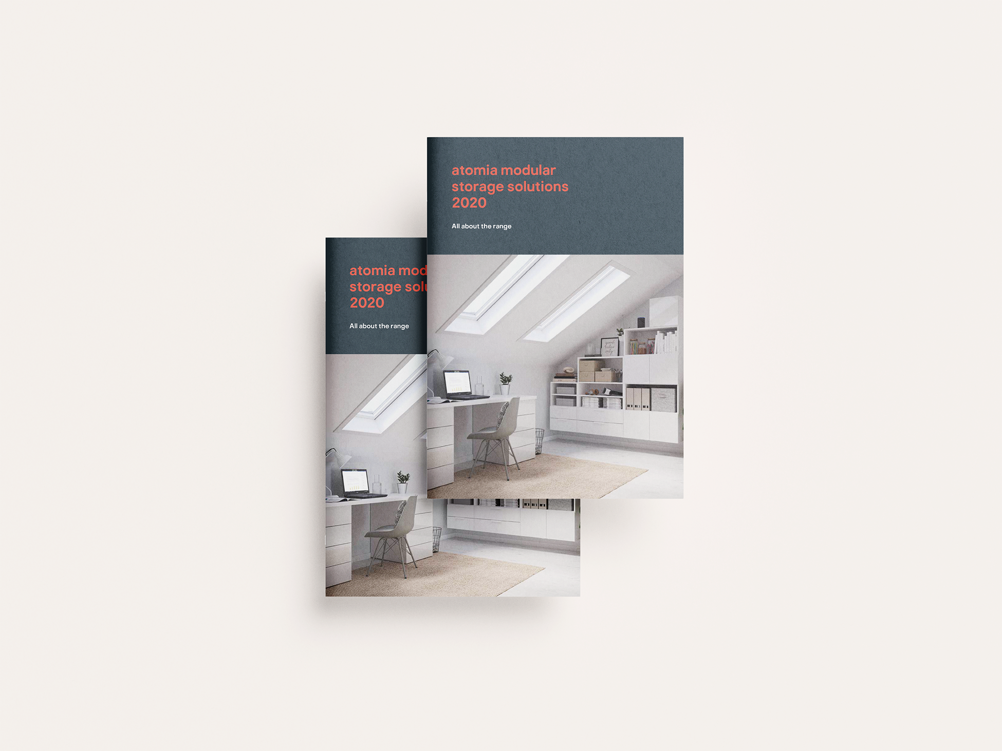 A brochure or magazine cover titled 'atomia modular storage solutions 2020' featuring a modern attic room with skylight windows, a white desk, chairs, and storage shelves.