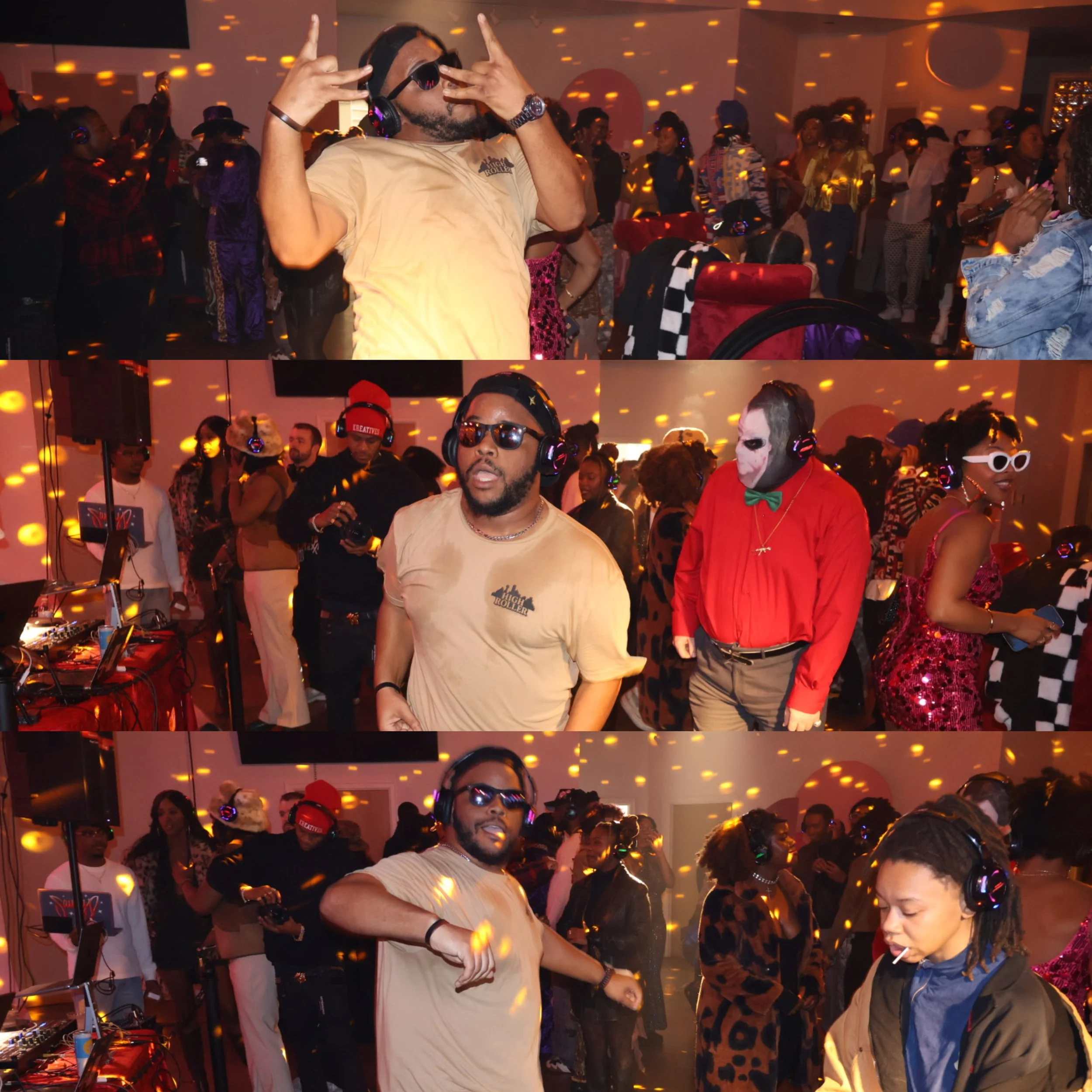 A crowded party or nightclub scene with people dancing and socializing. A man in the foreground is wearing a beige t-shirt and headphones, making hand gestures. The room is decorated with orange and yellow lights, creating a lively atmosphere.