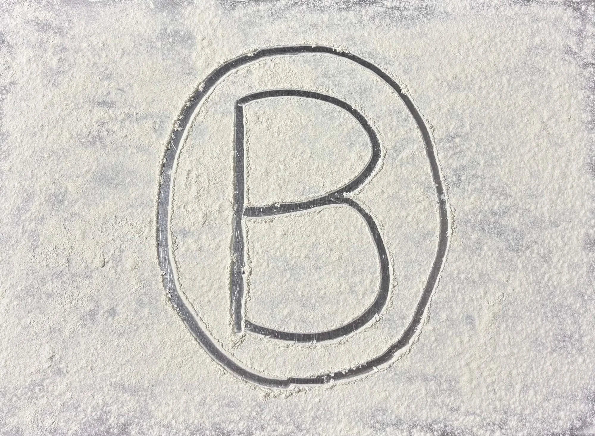 An ice skate blade pattern carved into snow.