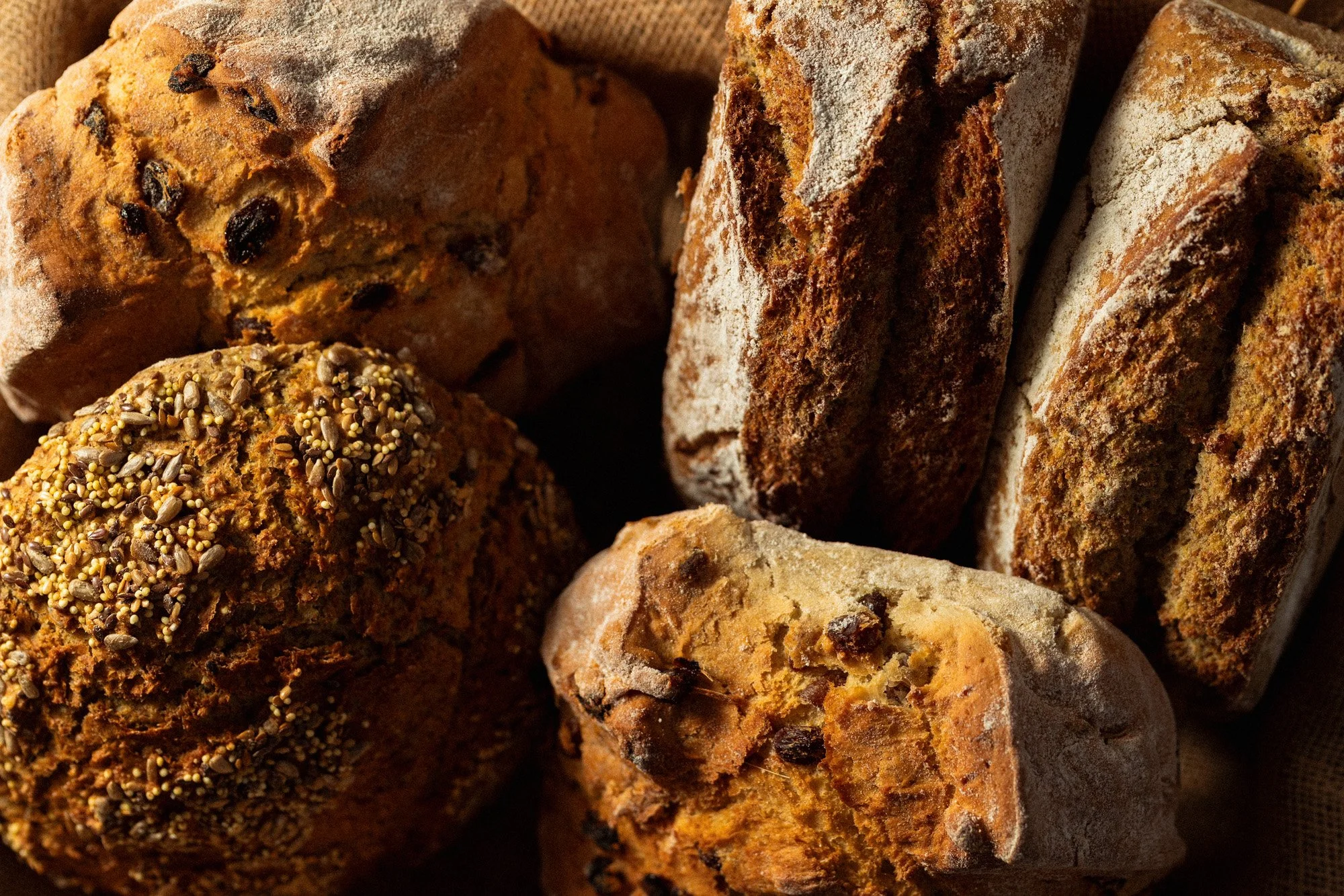 Assortment of artisan loaves including soda bread, seeded bread and fruit loaves freshly baked at O'Keeffe's Family Bakery.
