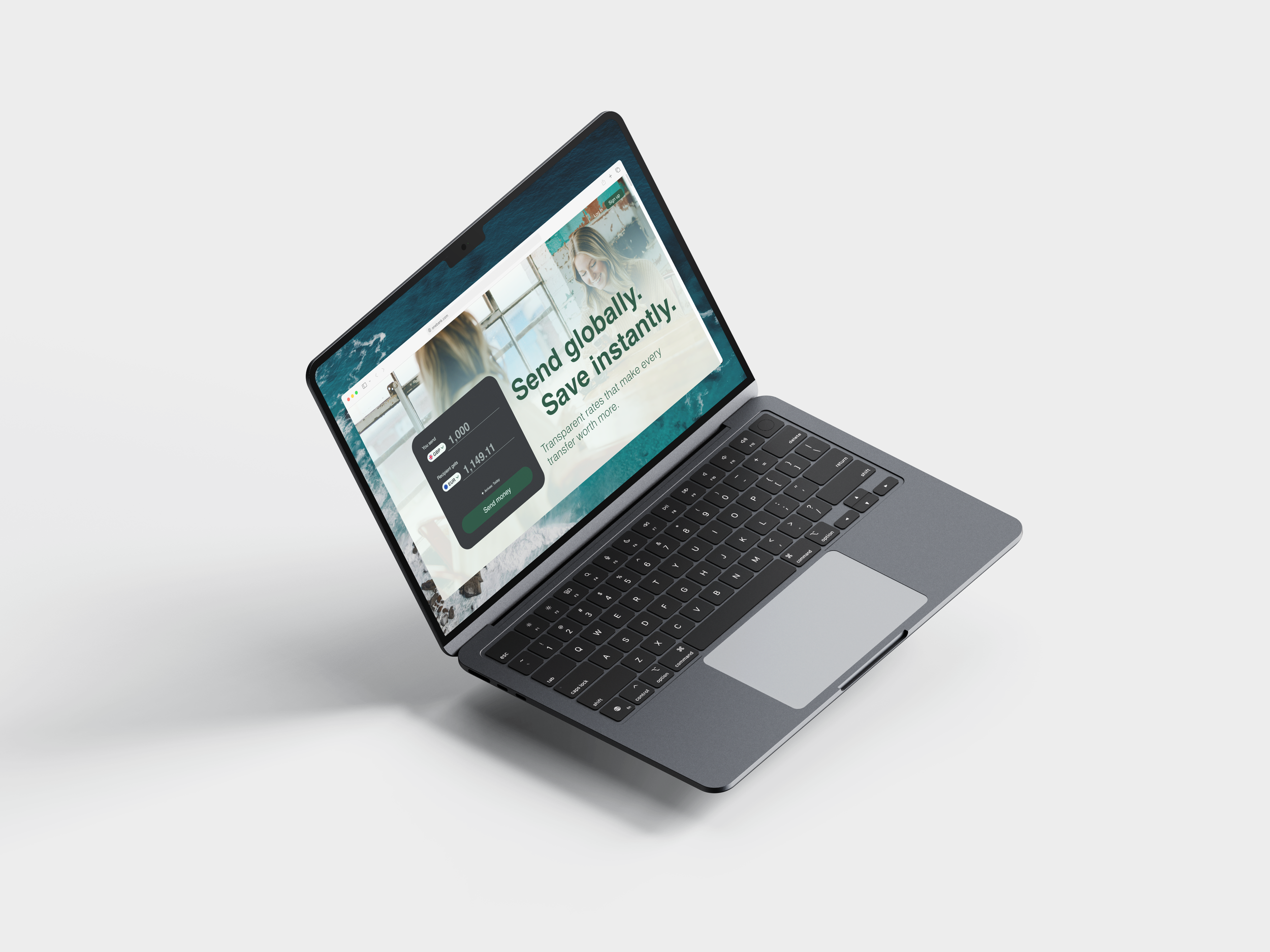 A silver laptop showing a webpage with a green and white background, images of women, and text that reads 'Send, globally, Save instantly' on a plain gray surface.